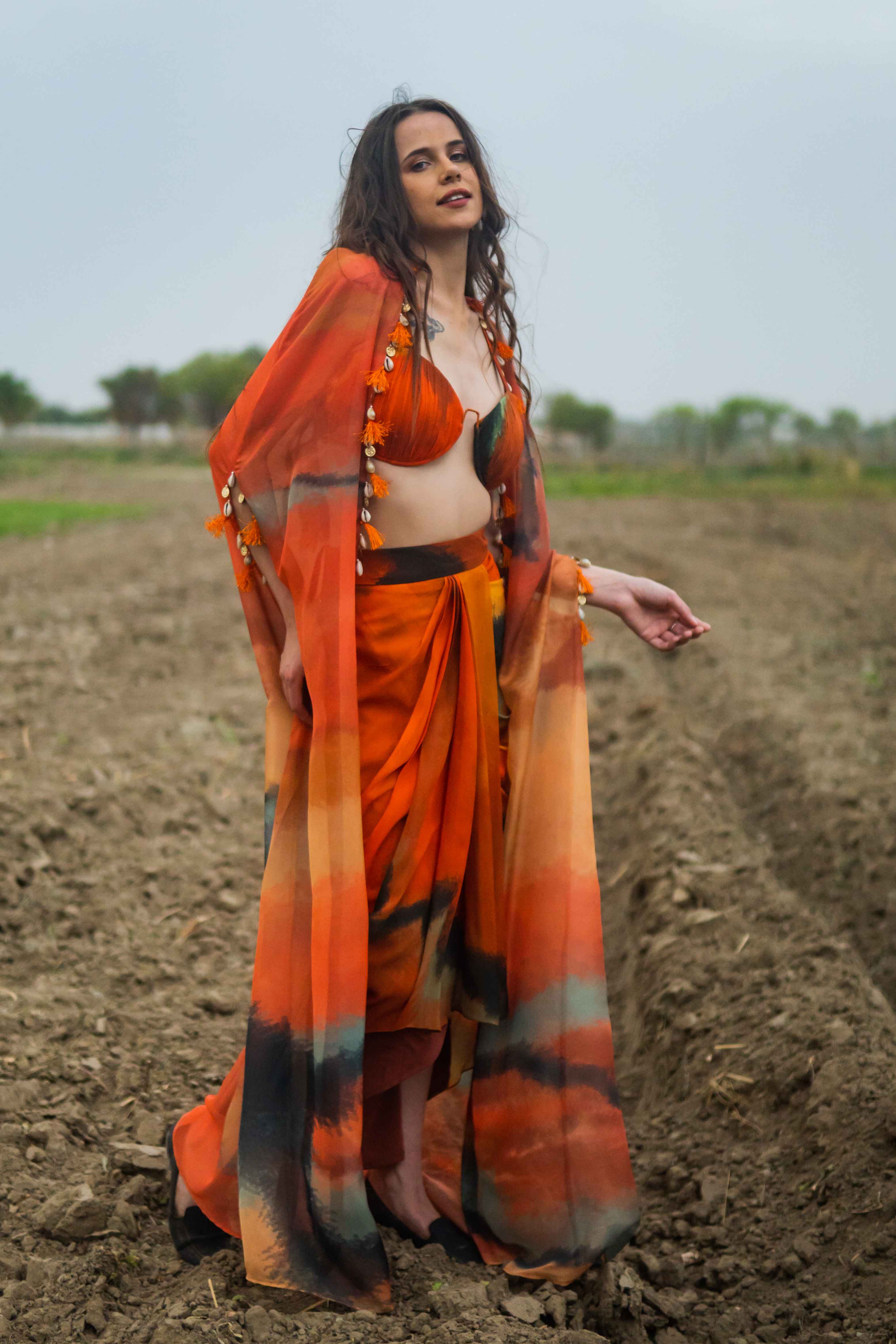 A model showcasing Amber Drift Cape Set by Miku Kumar from Miku Kumar's collection