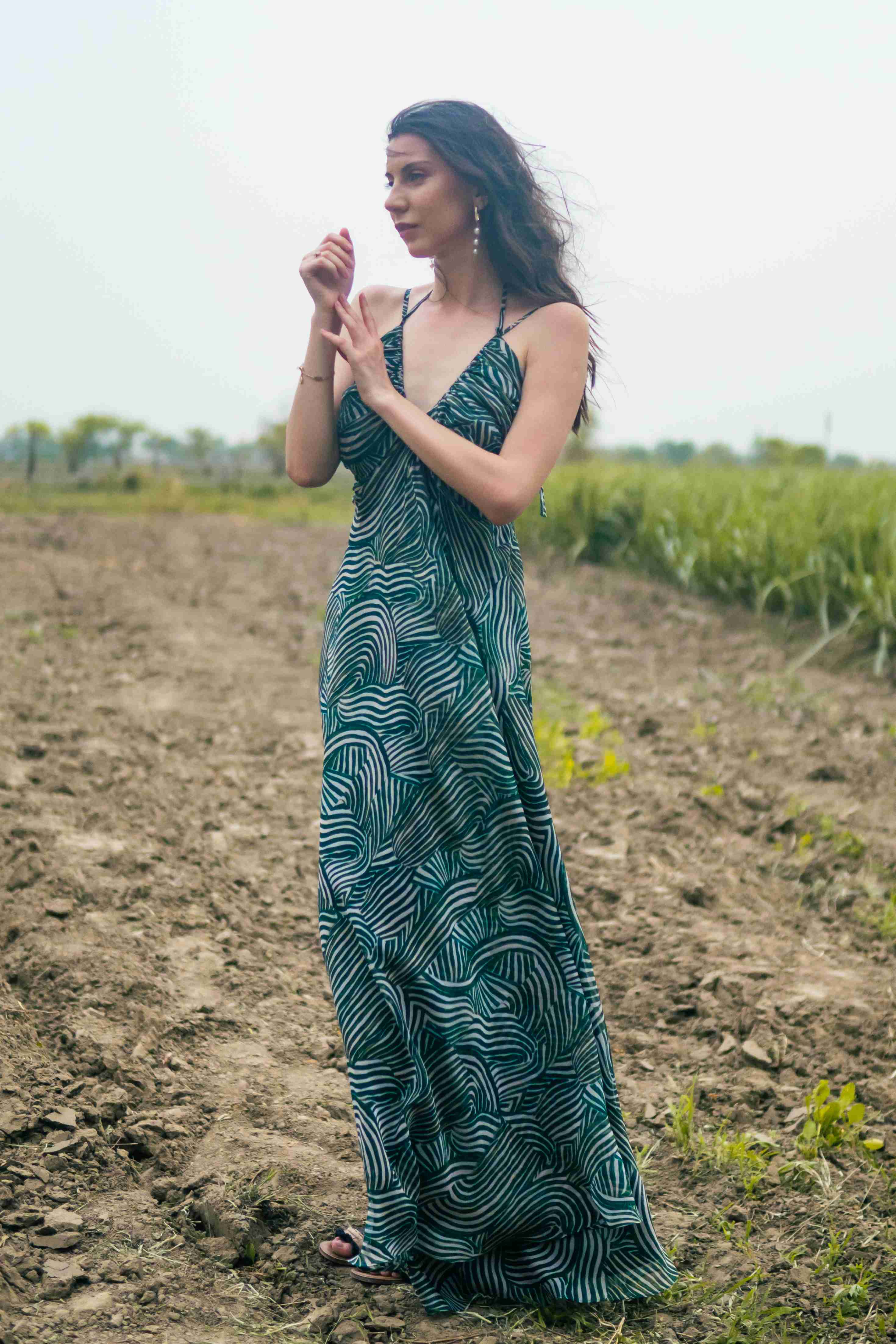A model showcasing Palm Escape Maxi Dress by Miku Kumar from Miku Kumar's collection