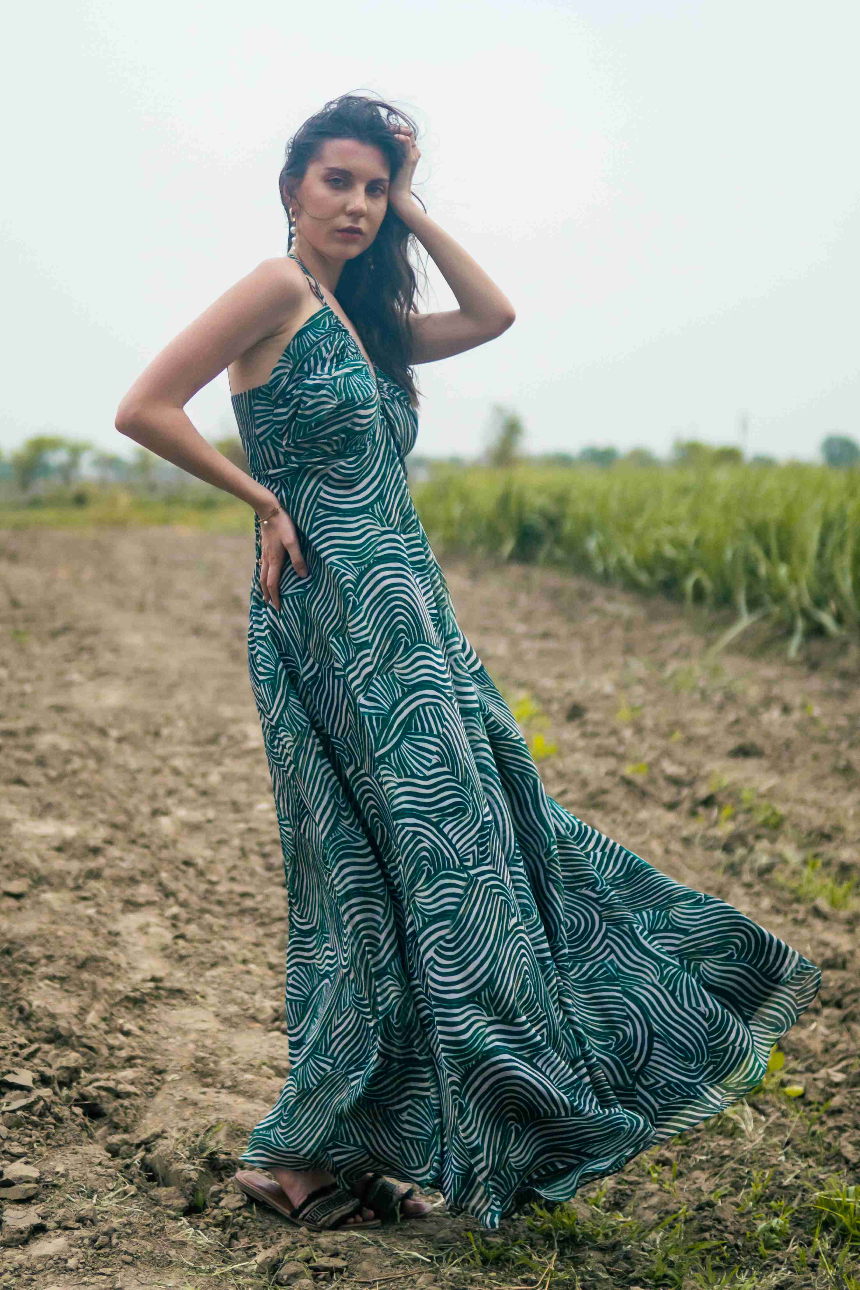 A model showcasing Palm Escape Maxi Dress by Miku Kumar from Miku Kumar's collection