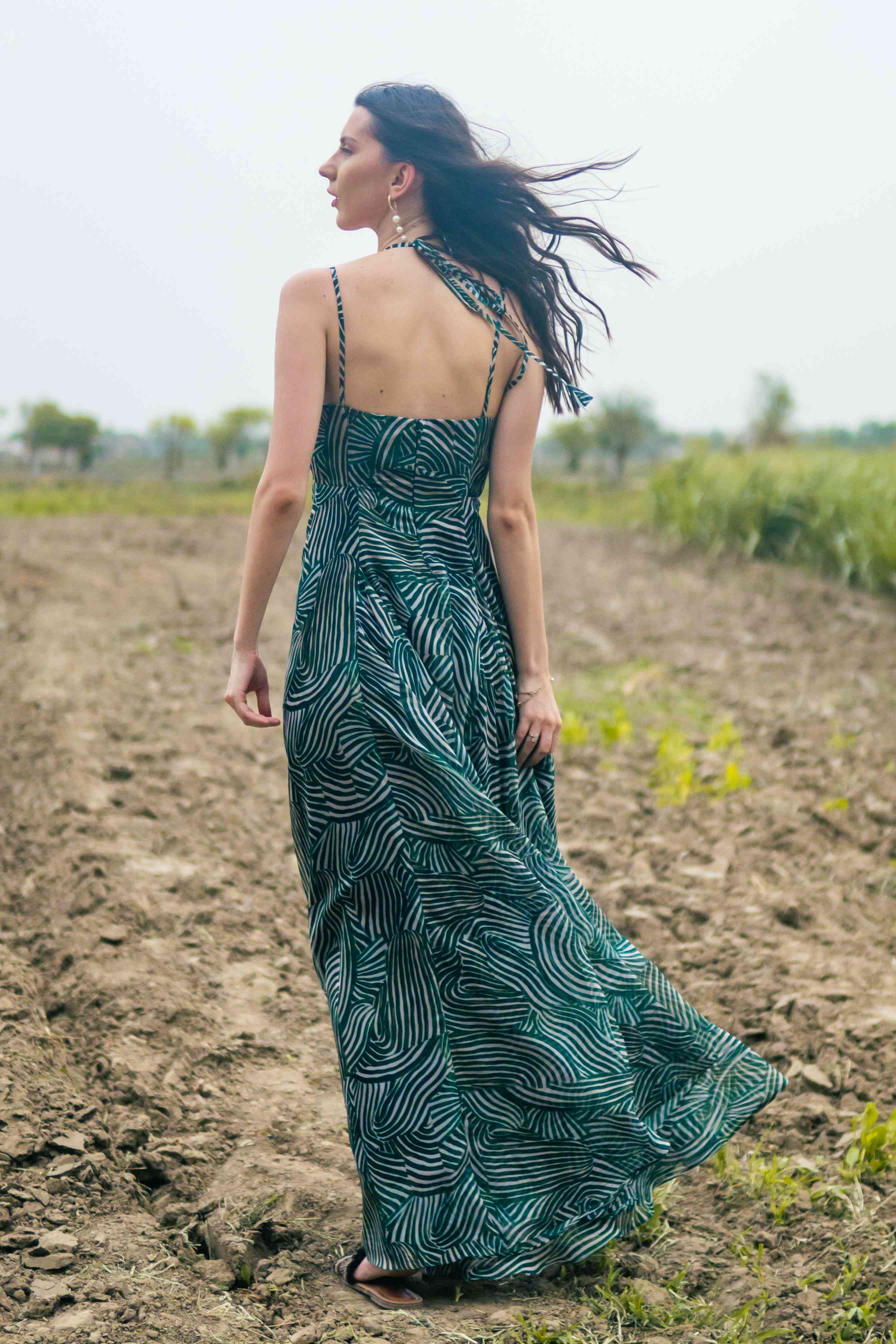 A model showcasing Palm Escape Maxi Dress by Miku Kumar from Miku Kumar's collection