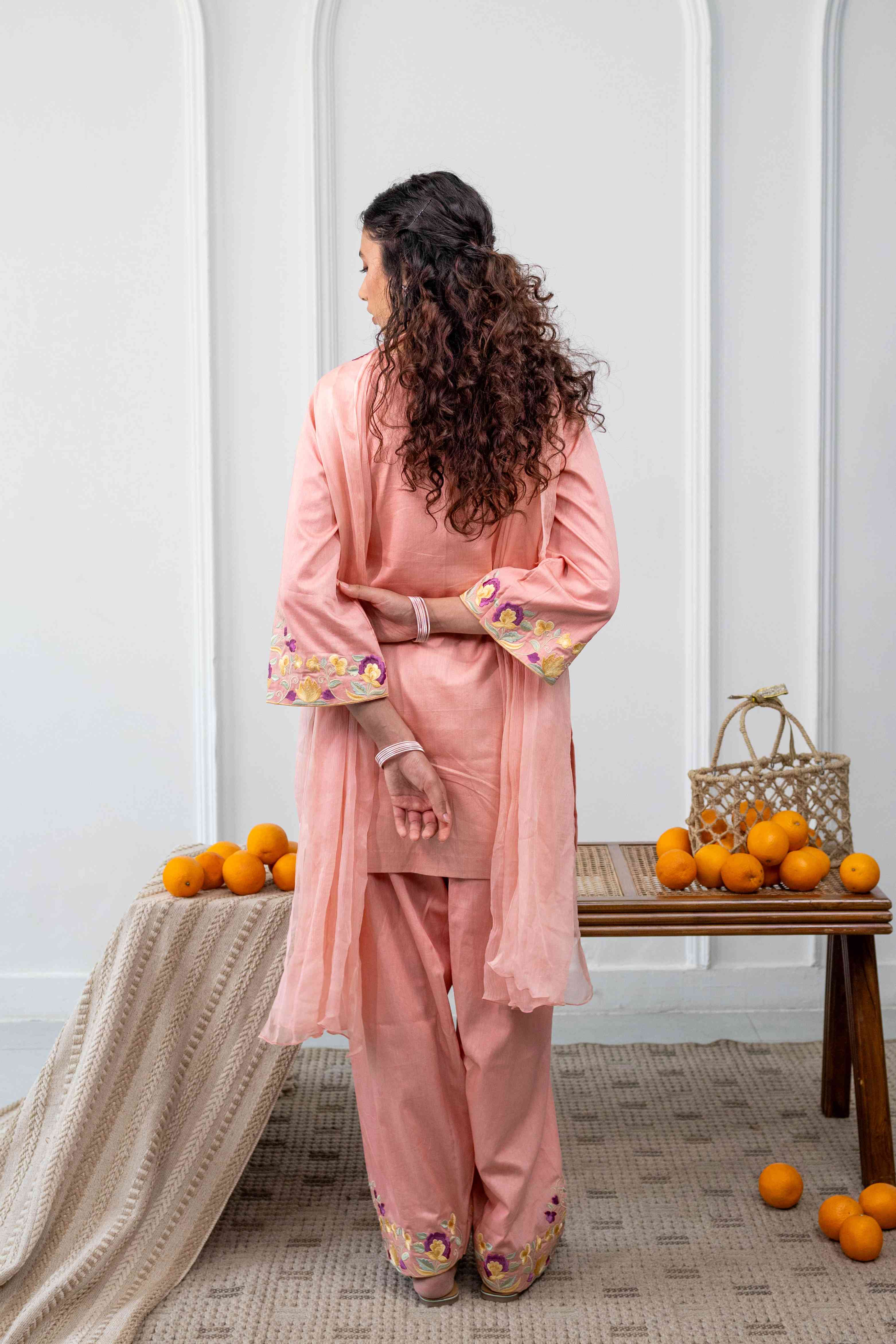 A model showcasing Kamal Coral Farshi Salwar Set by Gaamya from Gaamya's collection