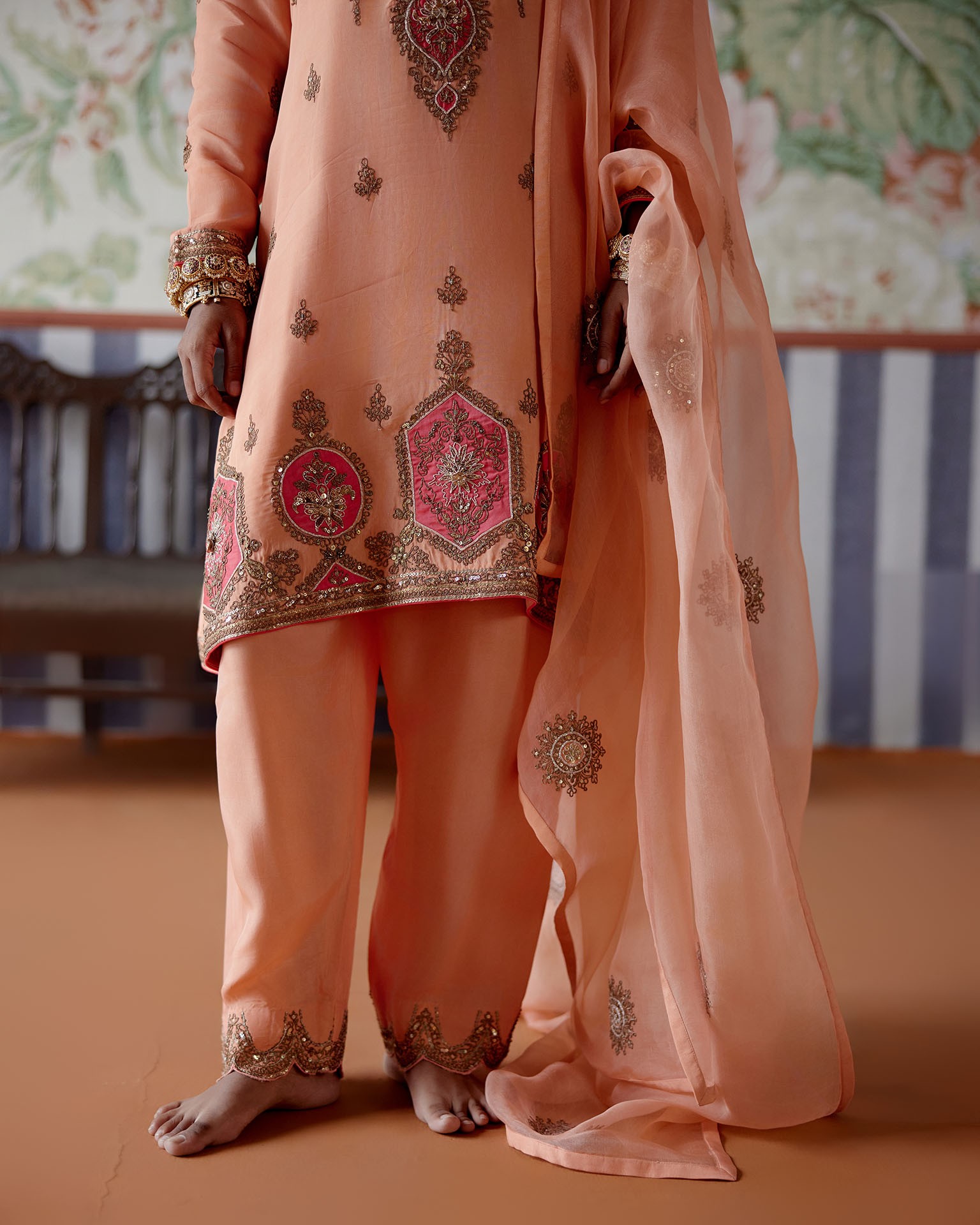 A model showcasing Peach Embroidered Kurta Set by Pooja Singhal from Pooja Singhal's collection