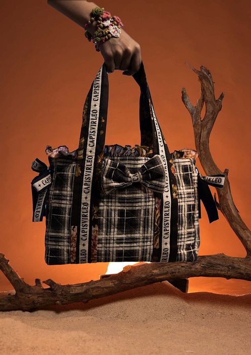 A model showcasing Black Baga Bag by Capisvirleo from Capisvirleo's collection A model showcasing Black Baga Bag by Capisvirleo from Capisvirleo's collection