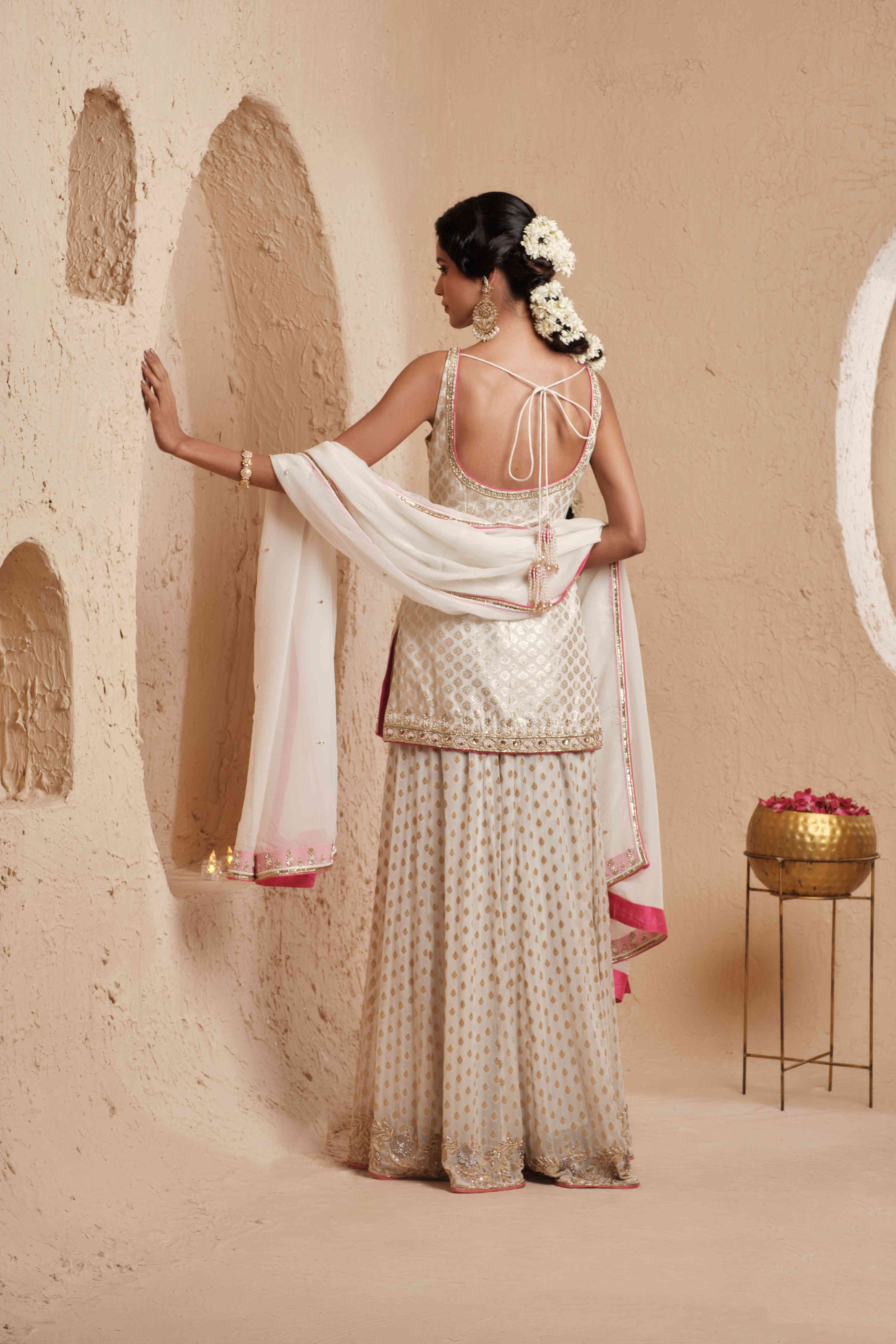 A model showcasing Suvarna Ivory Sharara Set by Muditaa By Urmila from Muditaa By Urmila's collection