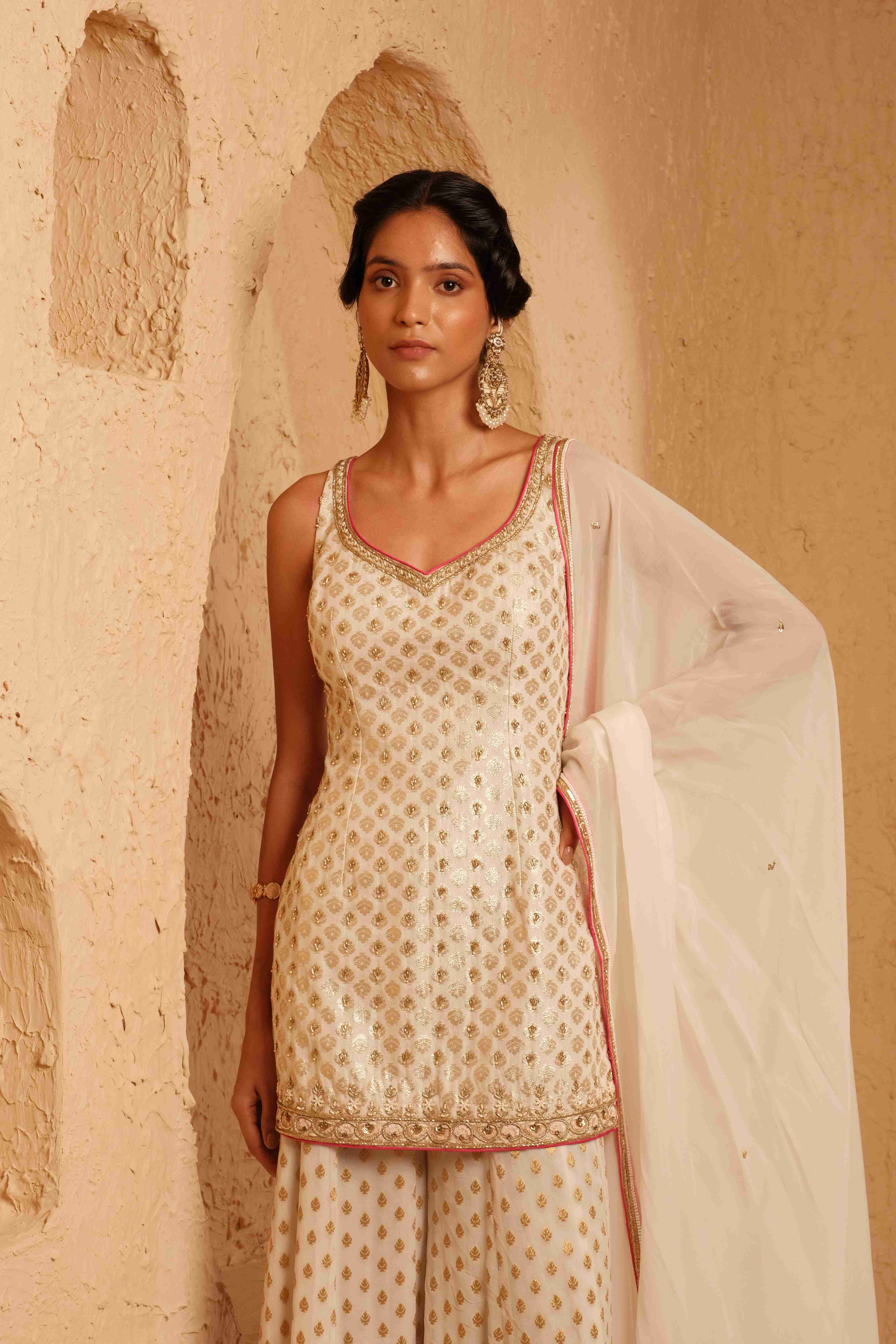 A model showcasing Suvarna Ivory Sharara Set by Muditaa By Urmila from Muditaa By Urmila's collection