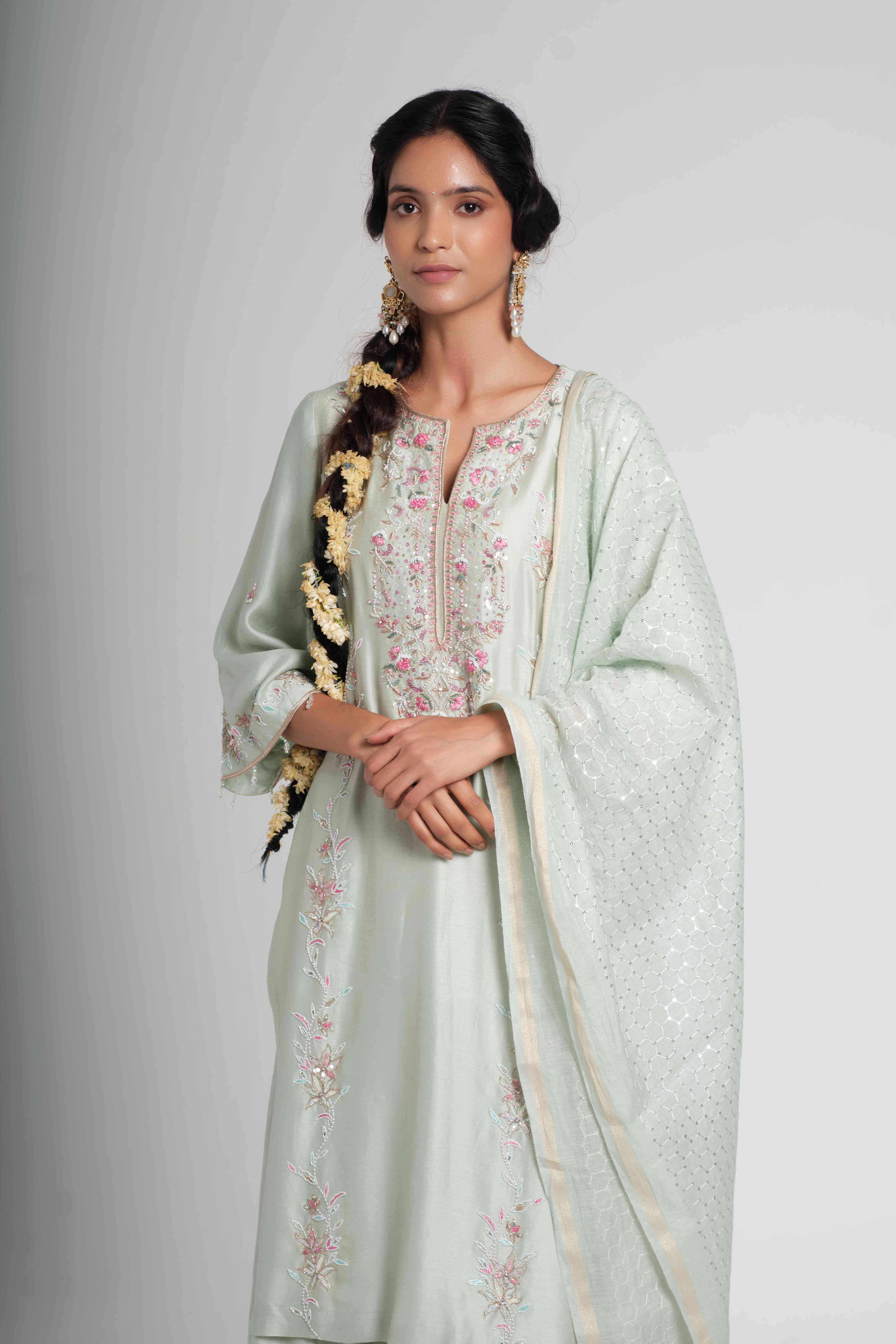 A model showcasing Tarini Pastel Sage Green Palazzo Set by Muditaa By Urmila from Muditaa By Urmila's collection