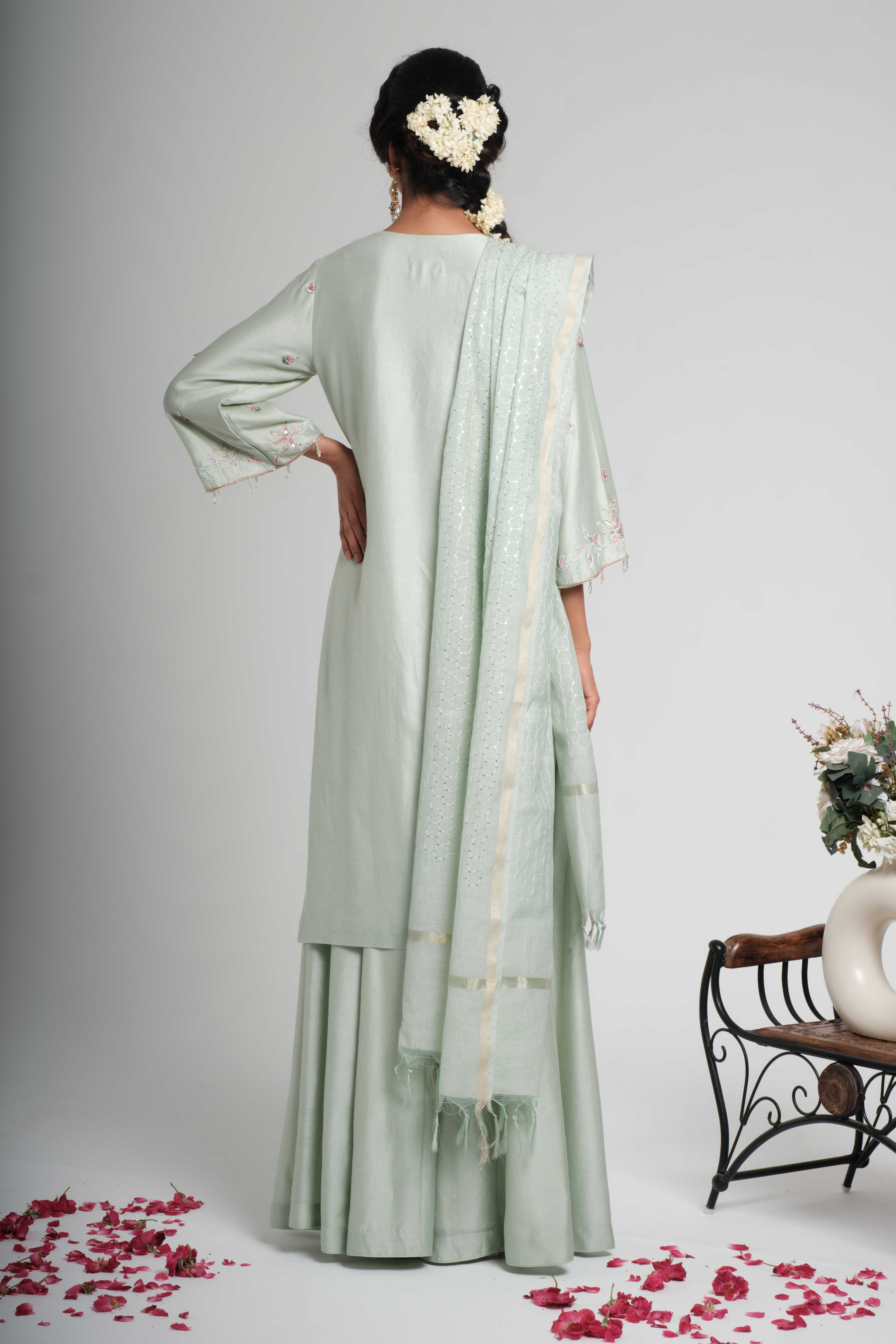 A model showcasing Tarini Pastel Sage Green Palazzo Set by Muditaa By Urmila from Muditaa By Urmila's collection