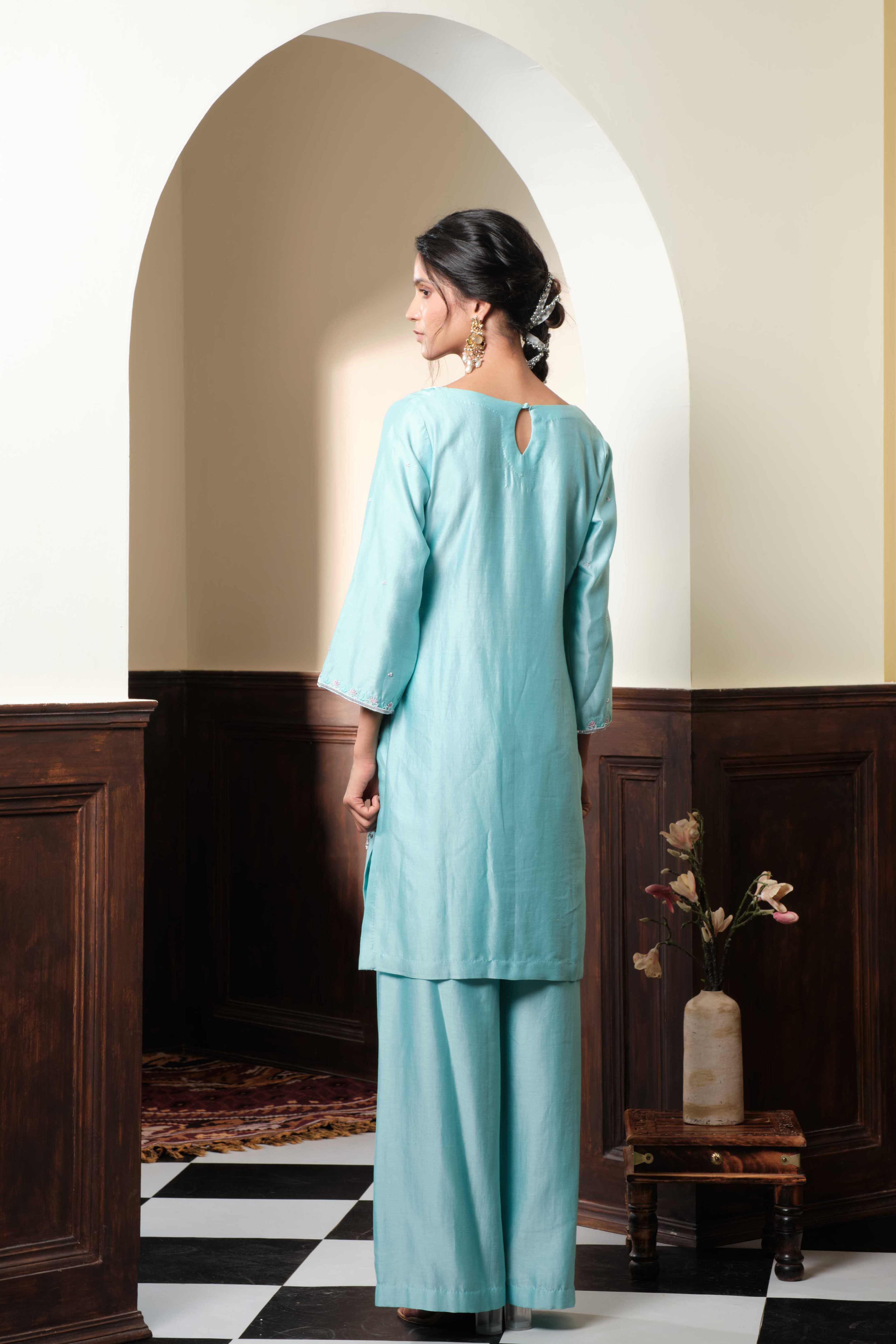 A model showcasing Meerika Pastel Blue Sharara Set by Muditaa By Urmila from Muditaa By Urmila's collection