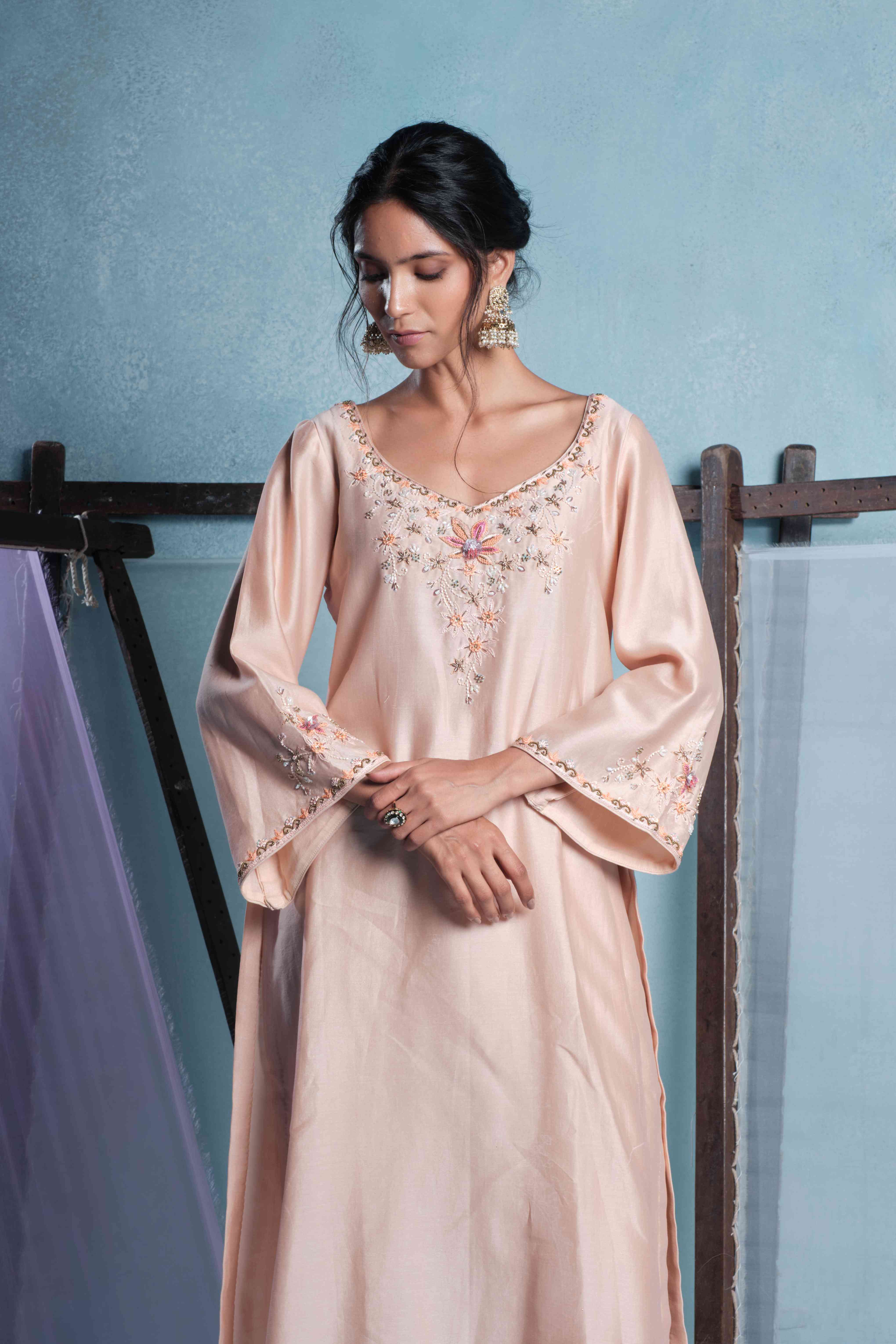 A model showcasing Amaya Peach Pants Set by Muditaa By Urmila from Muditaa By Urmila's collection