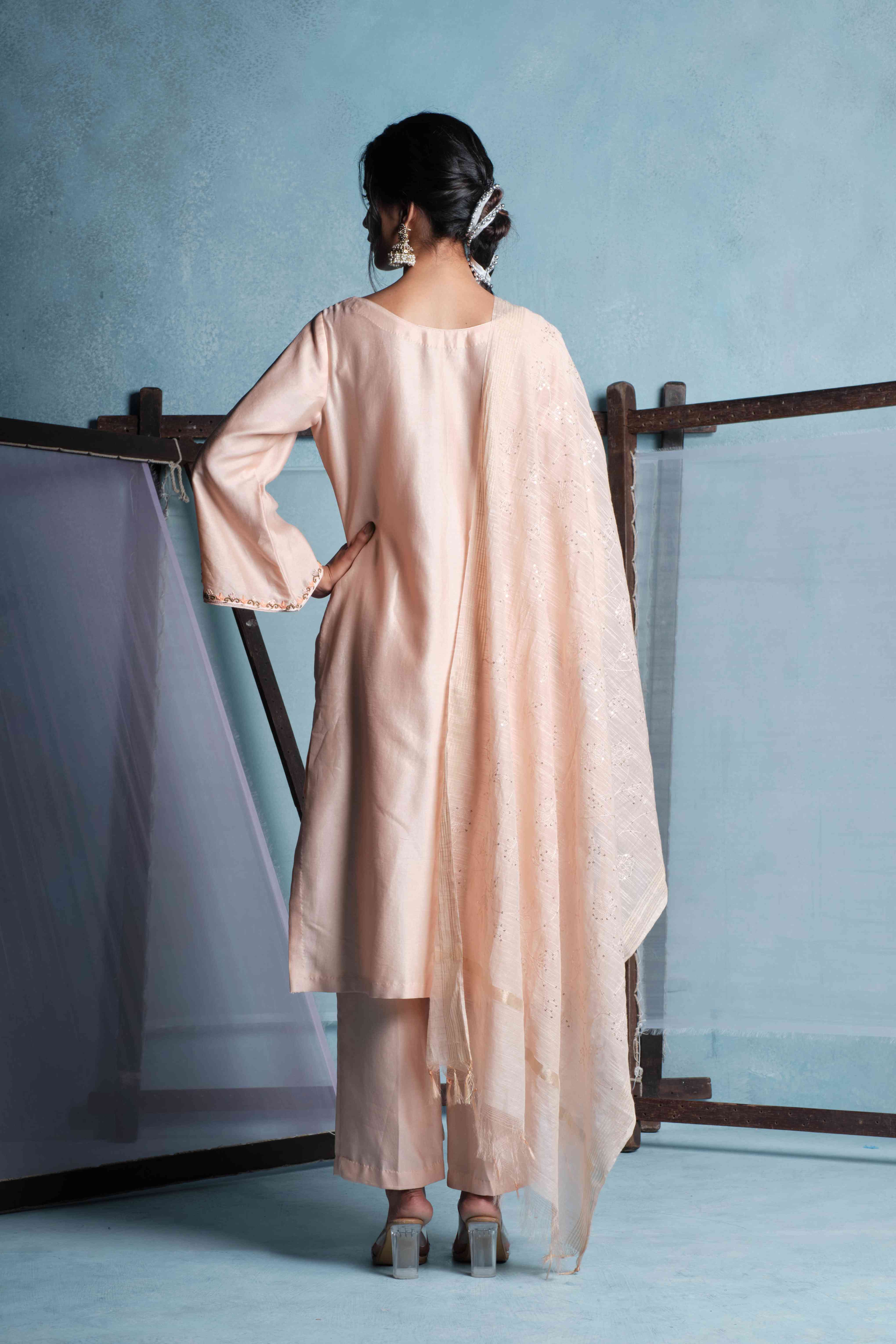 A model showcasing Amaya Peach Pants Set by Muditaa By Urmila from Muditaa By Urmila's collection