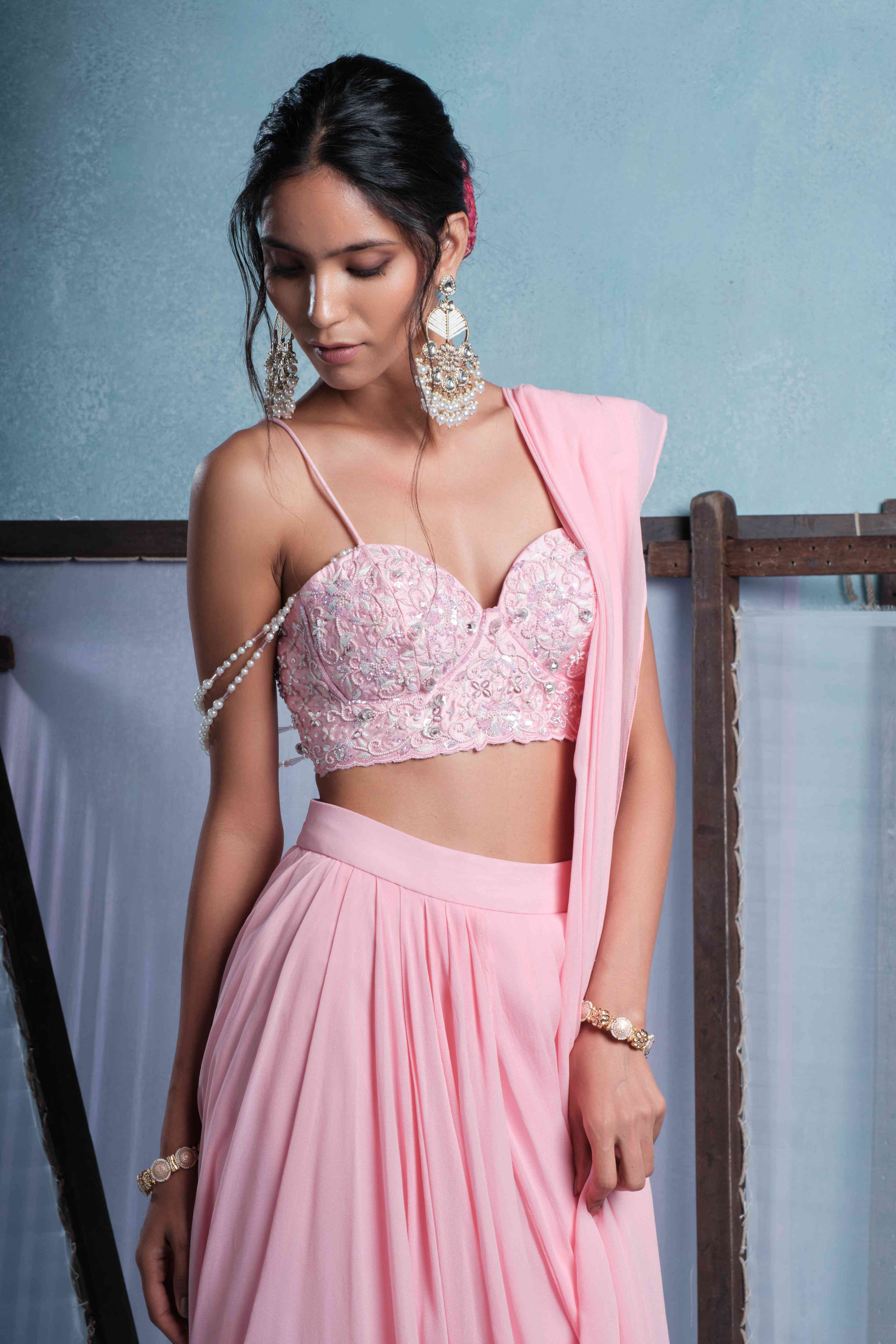 A model showcasing Nalini Blush Pink Draped Saree by Muditaa By Urmila from Muditaa By Urmila's collection
