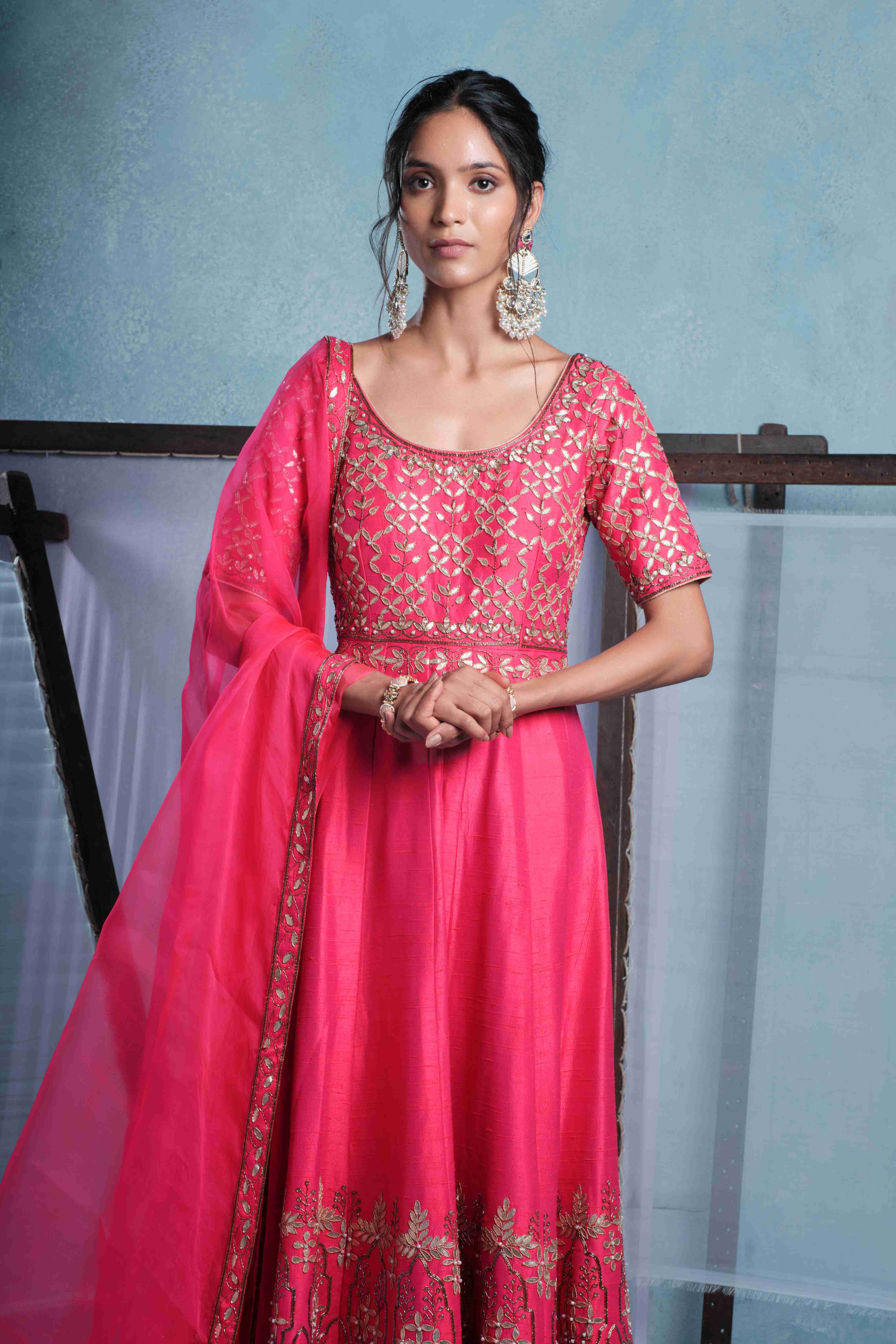 A model showcasing Mayra Fuschia Pink Anarkali Set by Muditaa By Urmila from Muditaa By Urmila's collection