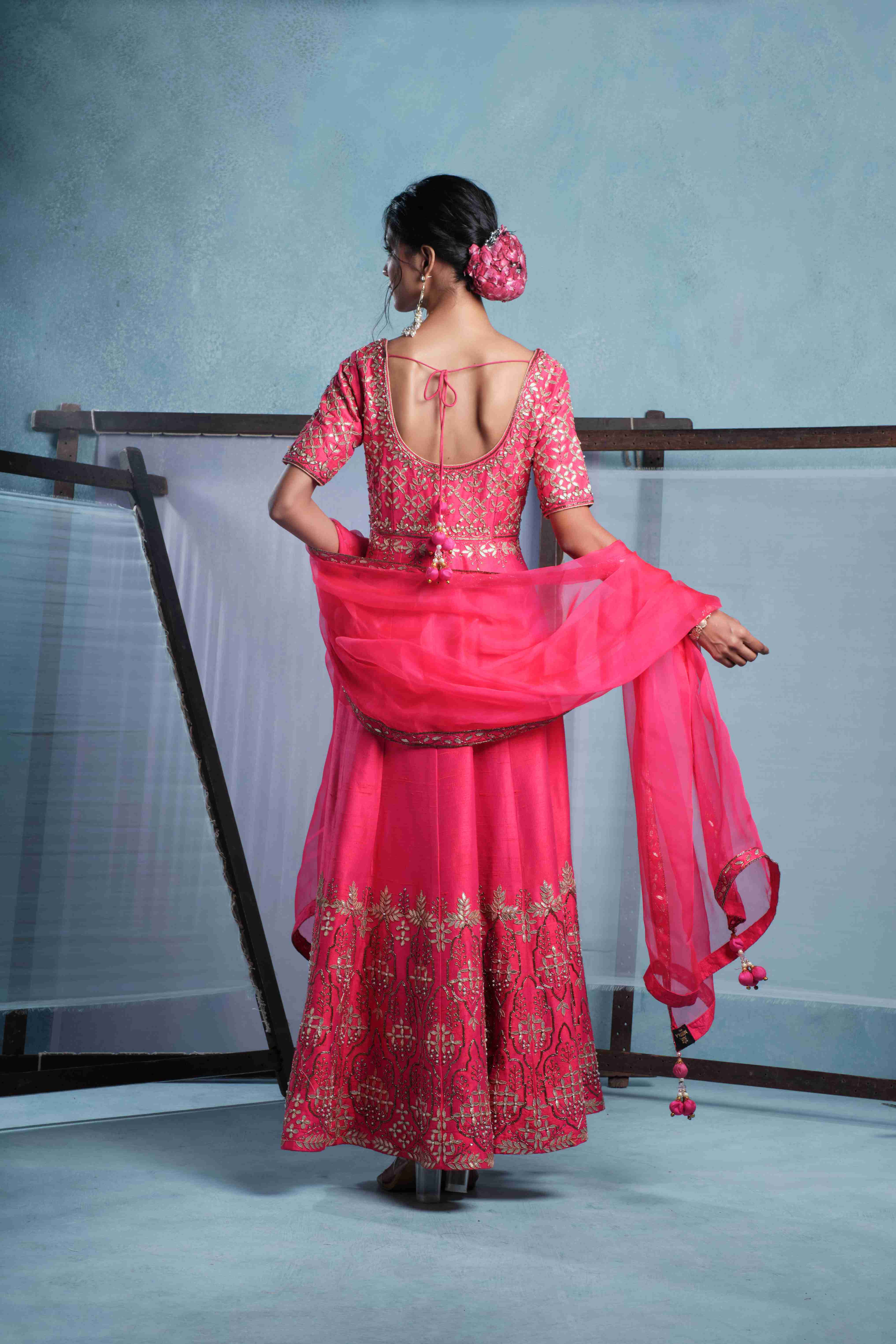 A model showcasing Mayra Fuschia Pink Anarkali Set by Muditaa By Urmila from Muditaa By Urmila's collection