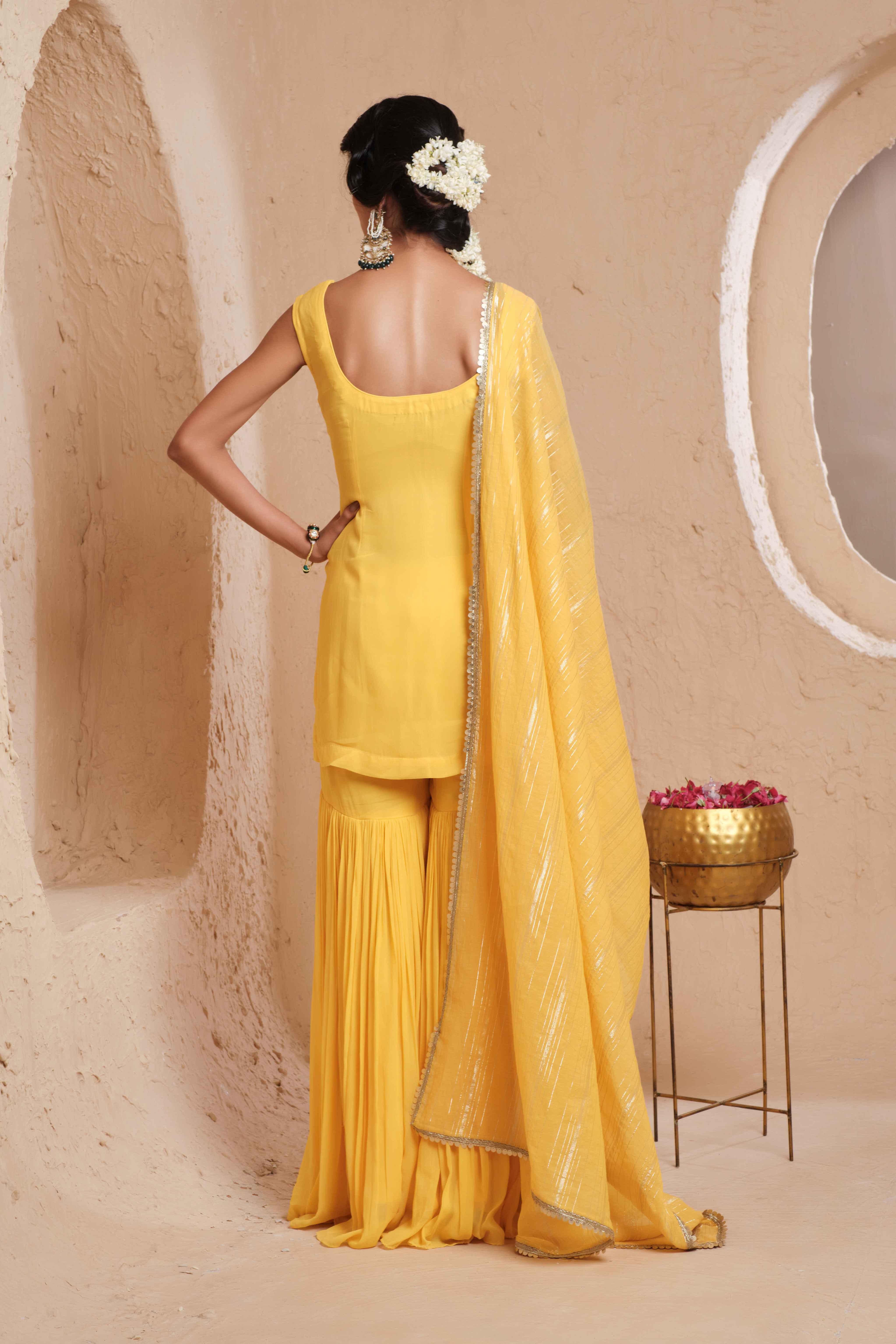 A model showcasing Dharvi Mustard Yellow Garara Set by Muditaa By Urmila from Muditaa By Urmila's collection