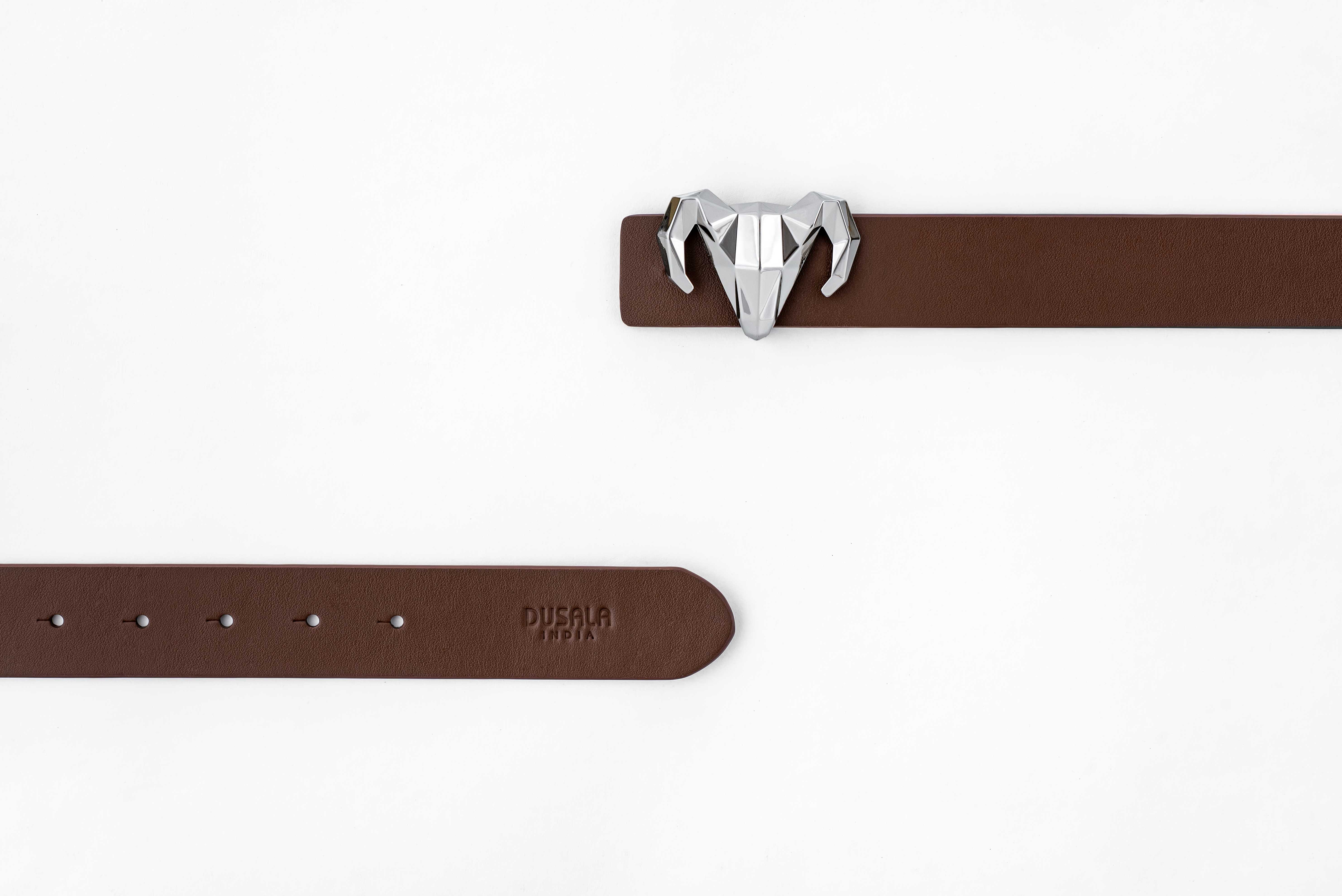 A model showcasing Italian Black Brown Leather Ram Buckle Reversible Belt by Dusala from Dusala's collection A model showcasing Italian Black Brown Leather Ram Buckle Reversible Belt by Dusala from Dusala's collection
