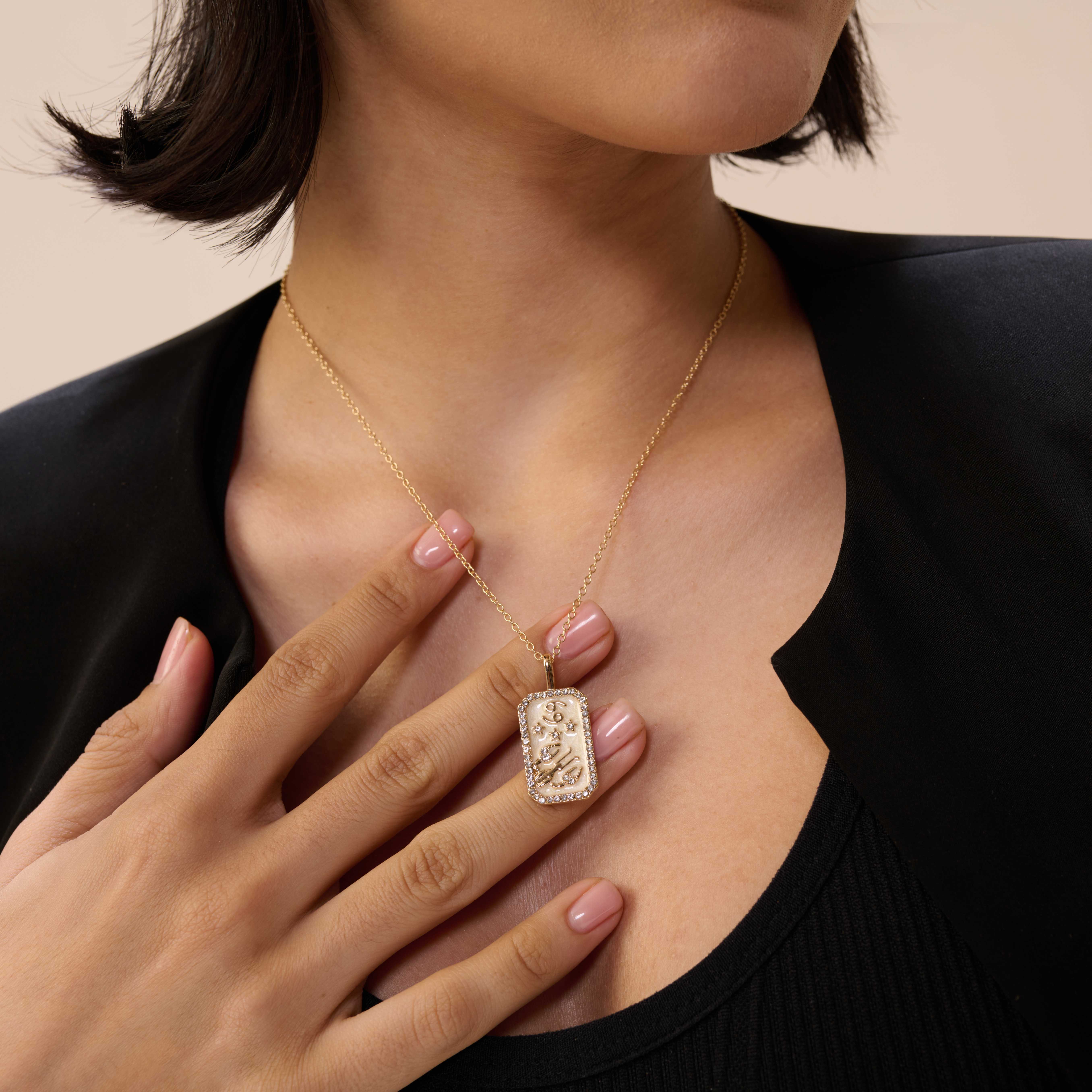 A model showcasing Cancer Zodiac Pendant by Dusala from Dusala's collection A model showcasing Cancer Zodiac Pendant by Dusala from Dusala's collection