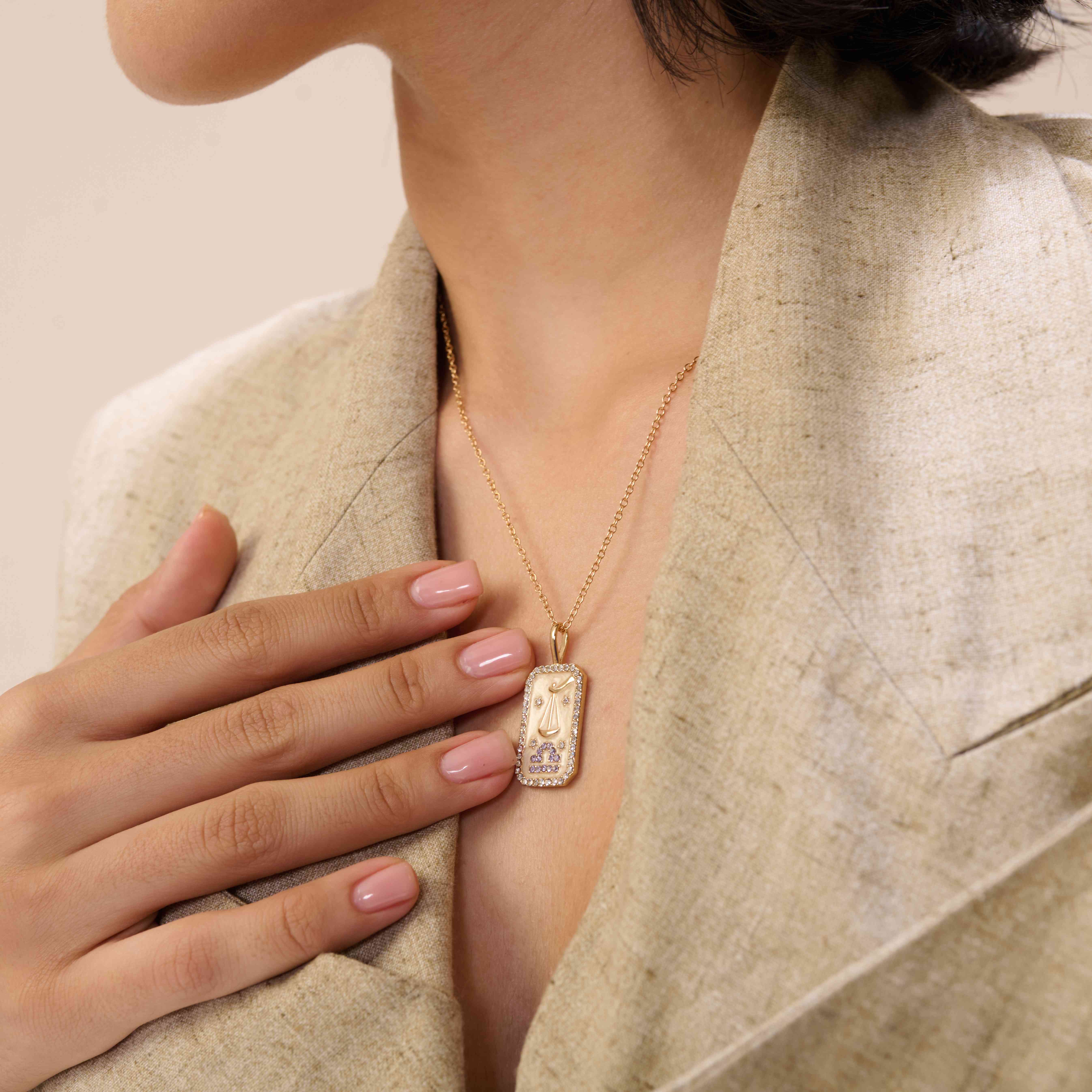 A model showcasing Libra Zodiac Pendant by Dusala from Dusala's collection A model showcasing Libra Zodiac Pendant by Dusala from Dusala's collection