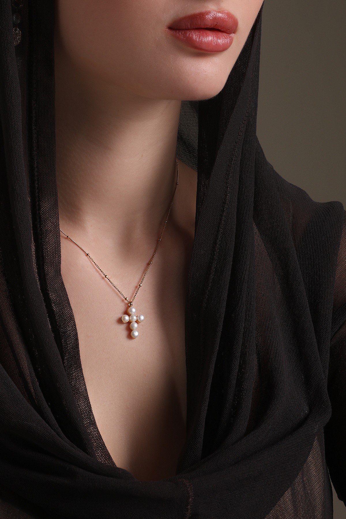 A model showcasing Cross Grace Pendant by Dusala from Dusala's collection A model showcasing Cross Grace Pendant by Dusala from Dusala's collection
