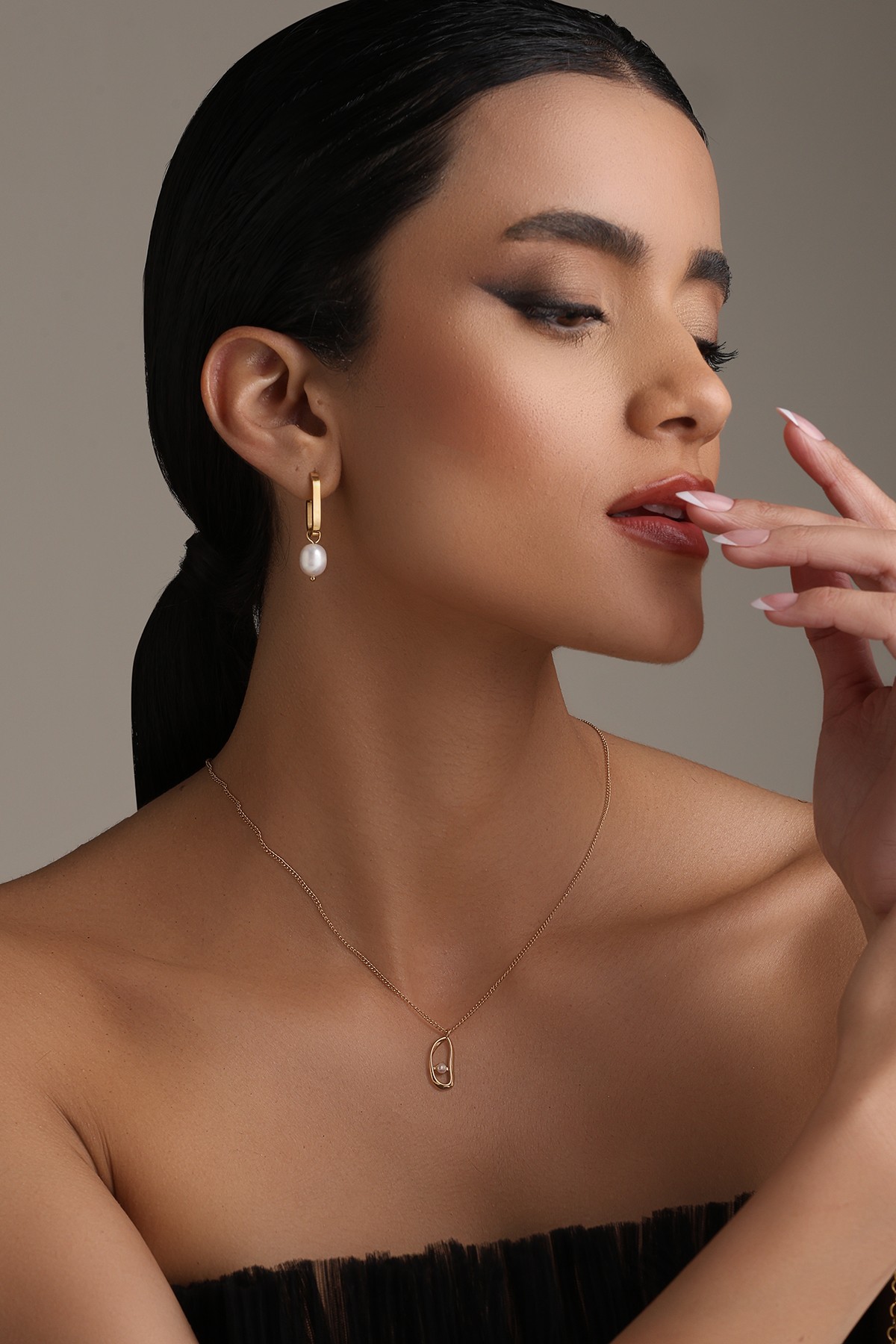 A model showcasing Dangle Dream Earrings by Dusala from Dusala's collection A model showcasing Dangle Dream Earrings by Dusala from Dusala's collection