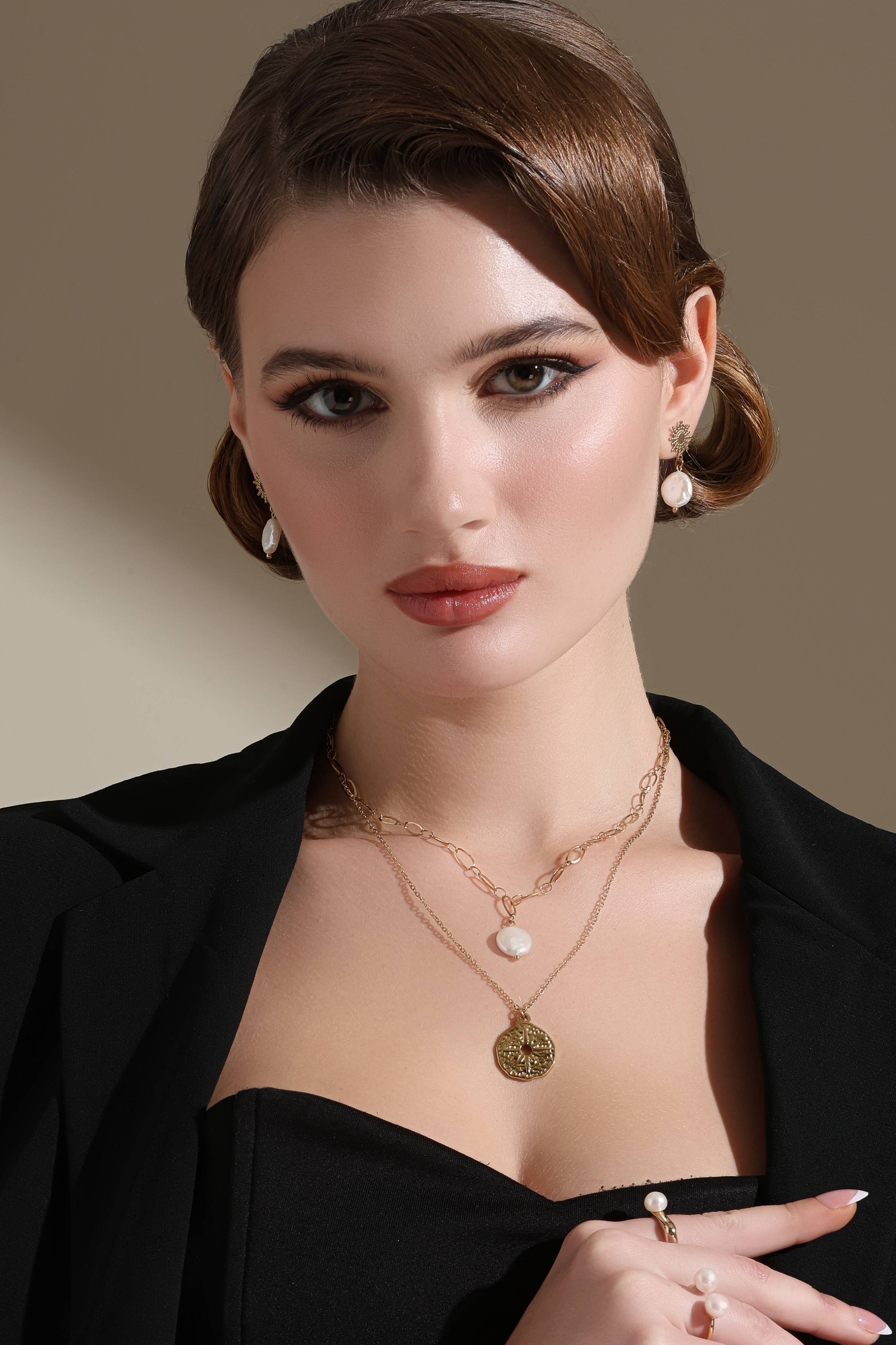 A model showcasing Snowflake Golden Earrings by Dusala from Dusala's collection