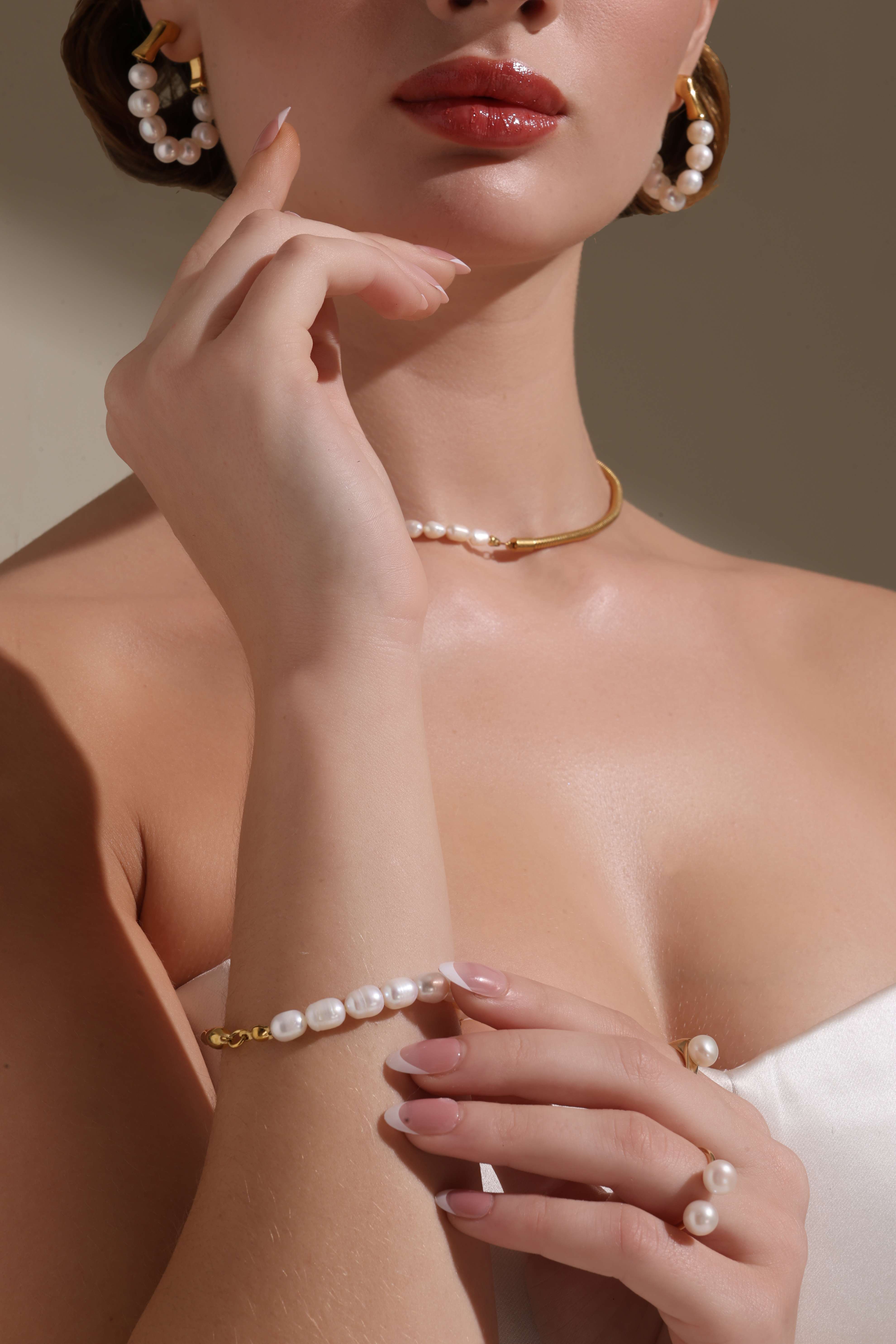 A model showcasing Timeless Pearl Bracelet by Dusala from Dusala's collection A model showcasing Timeless Pearl Bracelet by Dusala from Dusala's collection