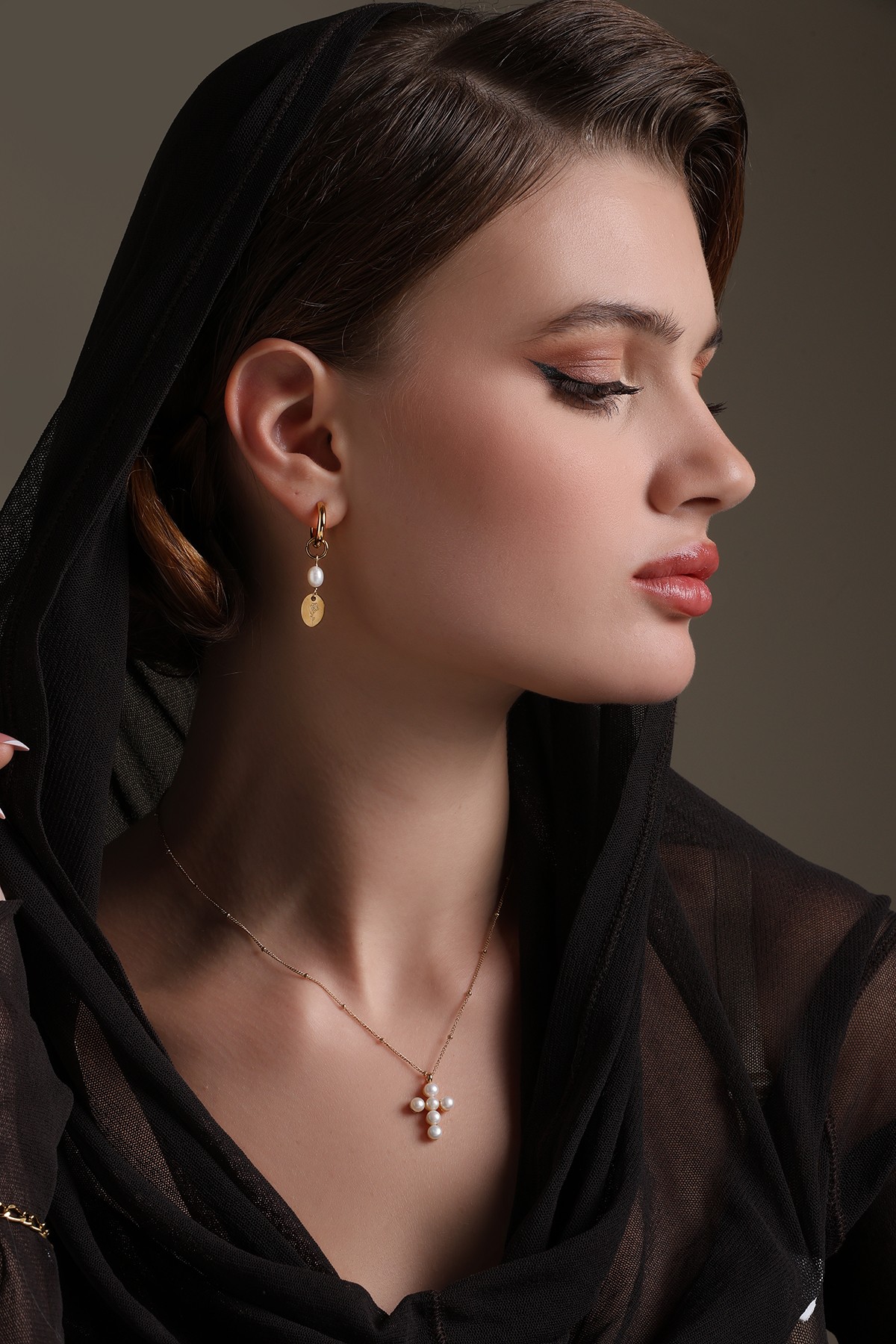 A model showcasing Flora Drop Golden Earrings by Dusala from Dusala's collection A model showcasing Flora Drop Golden Earrings by Dusala from Dusala's collection