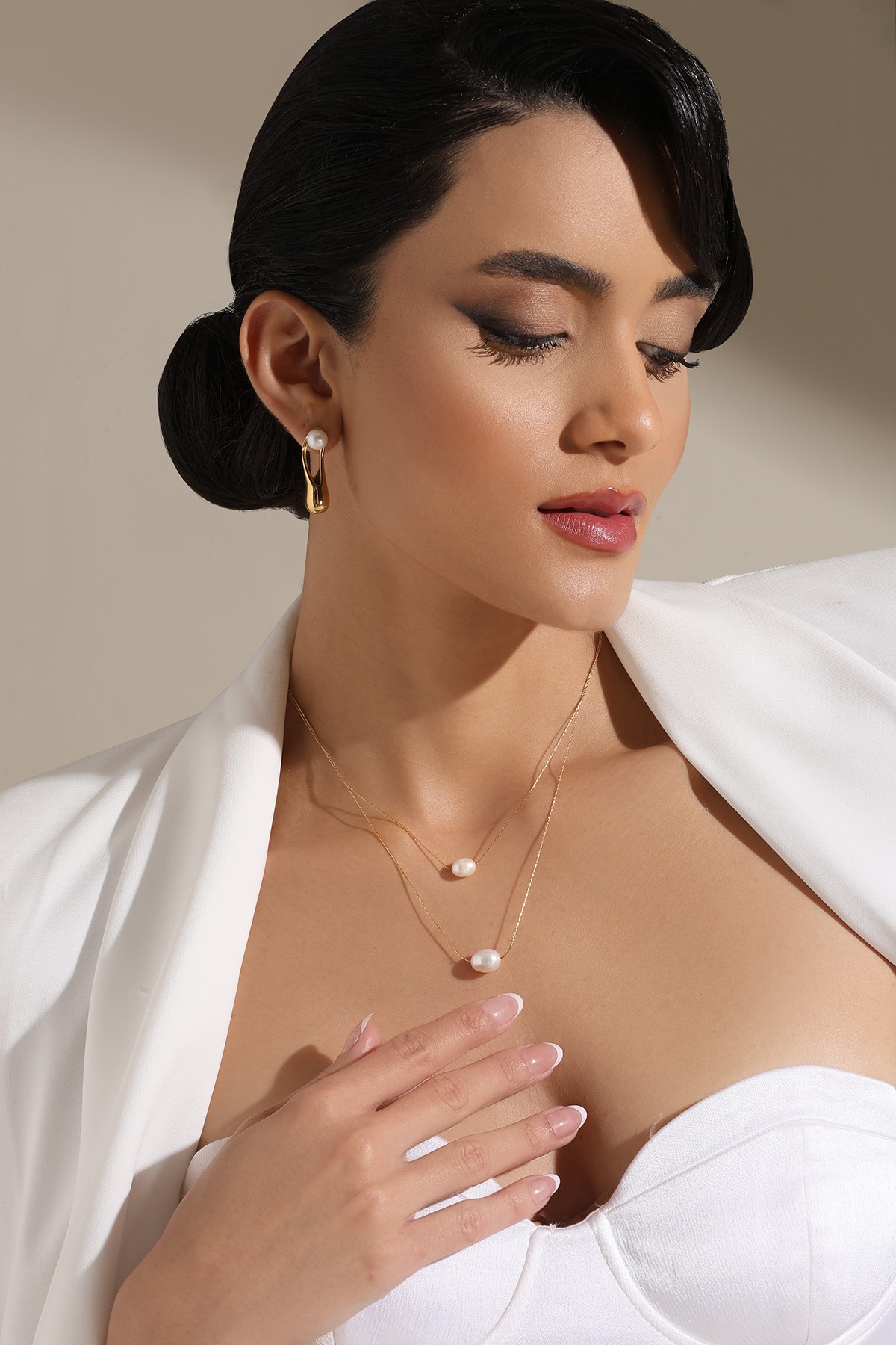 A model showcasing Layered Sophistication Pendant by Dusala from Dusala's collection A model showcasing Layered Sophistication Pendant by Dusala from Dusala's collection