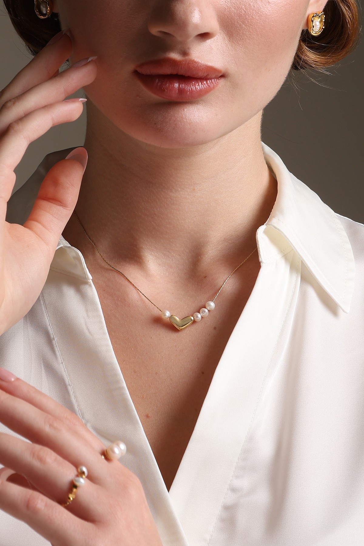A model showcasing Heart Celebration Pendant by Dusala from Dusala's collection A model showcasing Heart Celebration Pendant by Dusala from Dusala's collection