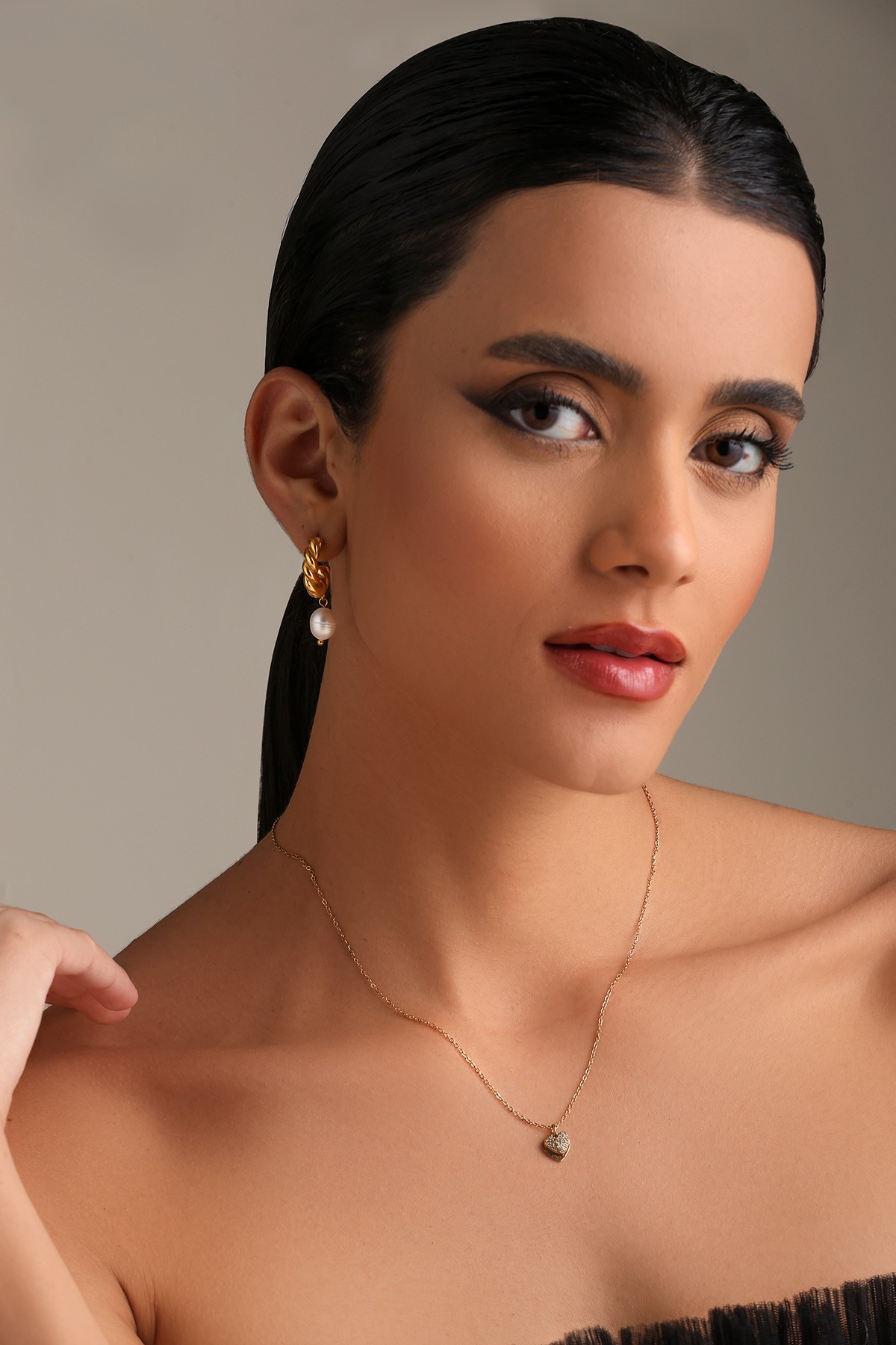 A model showcasing Heart Celebration Golden Pendant by Dusala from Dusala's collection