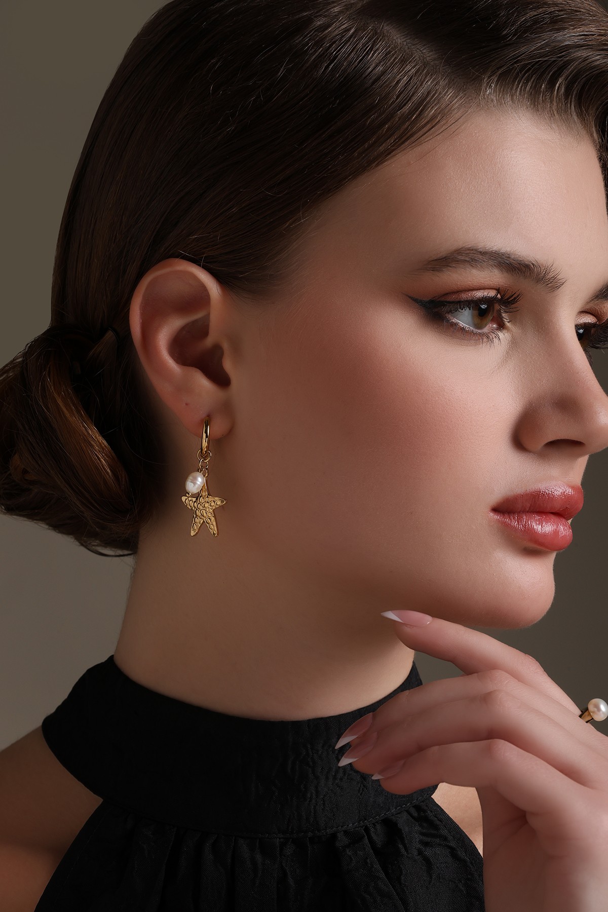 A model showcasing Ocean Star Earrings by Dusala from Dusala's collection A model showcasing Ocean Star Earrings by Dusala from Dusala's collection