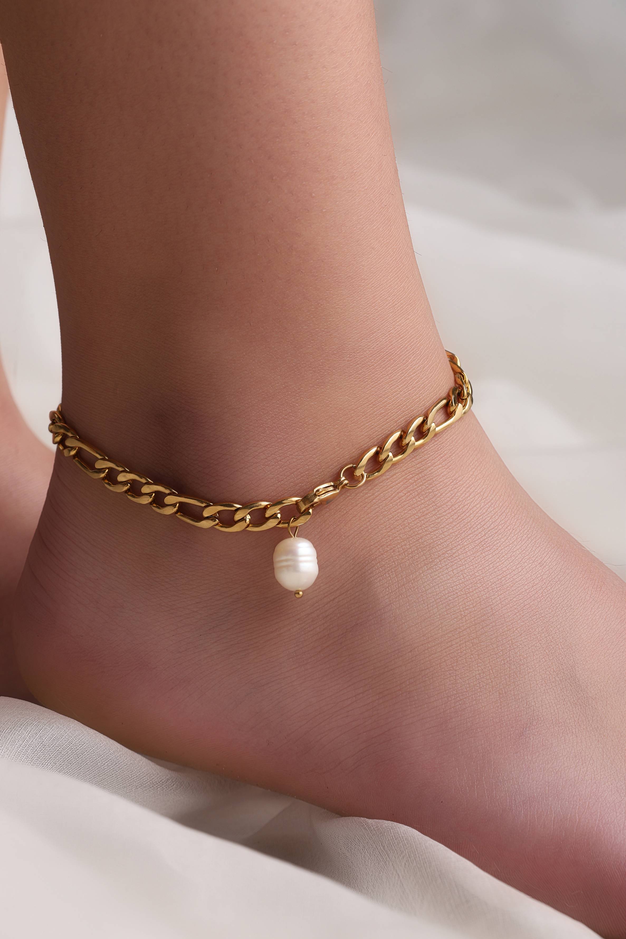 A model showcasing Pearl Ankle Anklet by Dusala from Dusala's collection A model showcasing Pearl Ankle Anklet by Dusala from Dusala's collection