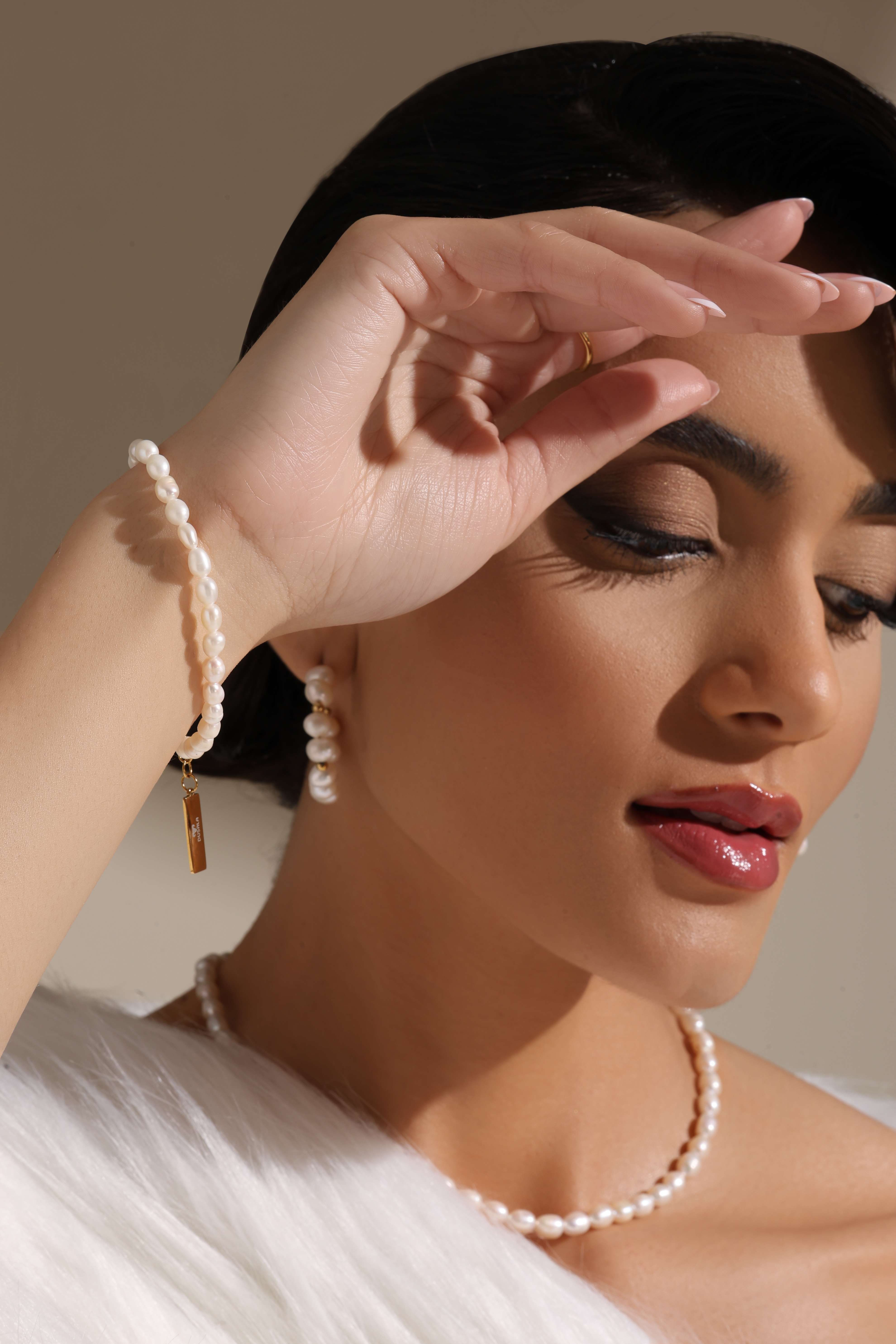 A model showcasing Love Pearl Charm Bracelet by Dusala from Dusala's collection