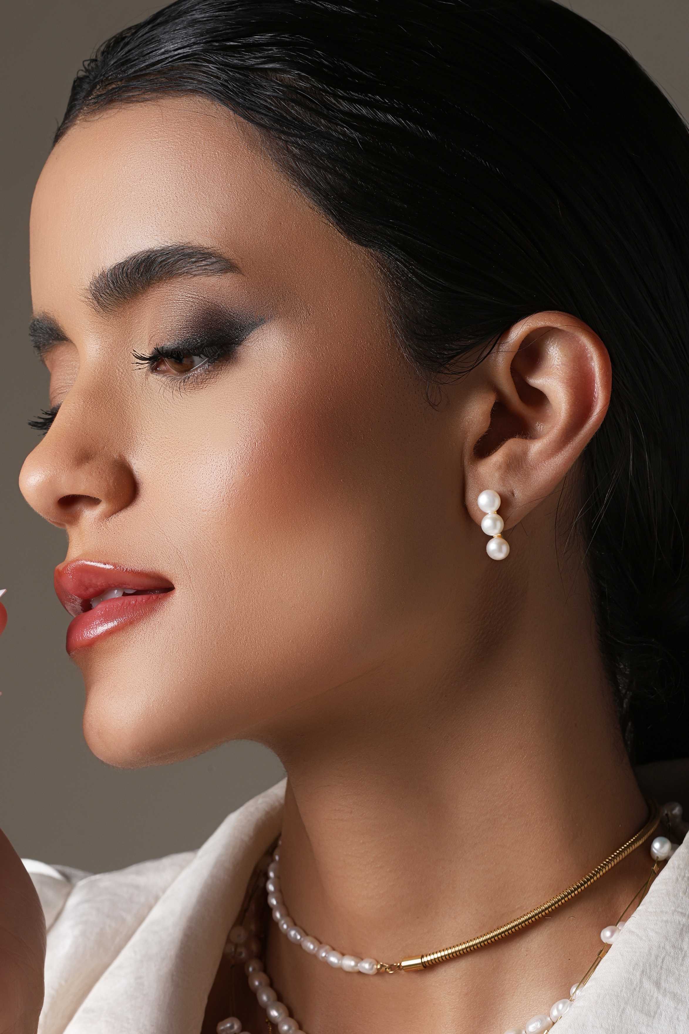 A model showcasing Chic Studs Earrings by Dusala from Dusala's collection A model showcasing Chic Studs Earrings by Dusala from Dusala's collection