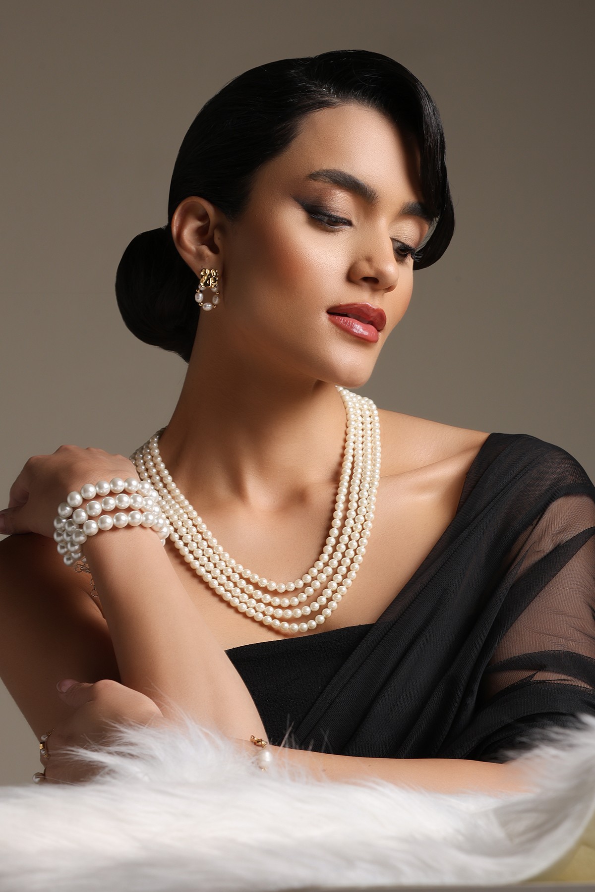 A model showcasing Four Strand Mala by Dusala from Dusala's collection A model showcasing Four Strand Mala by Dusala from Dusala's collection