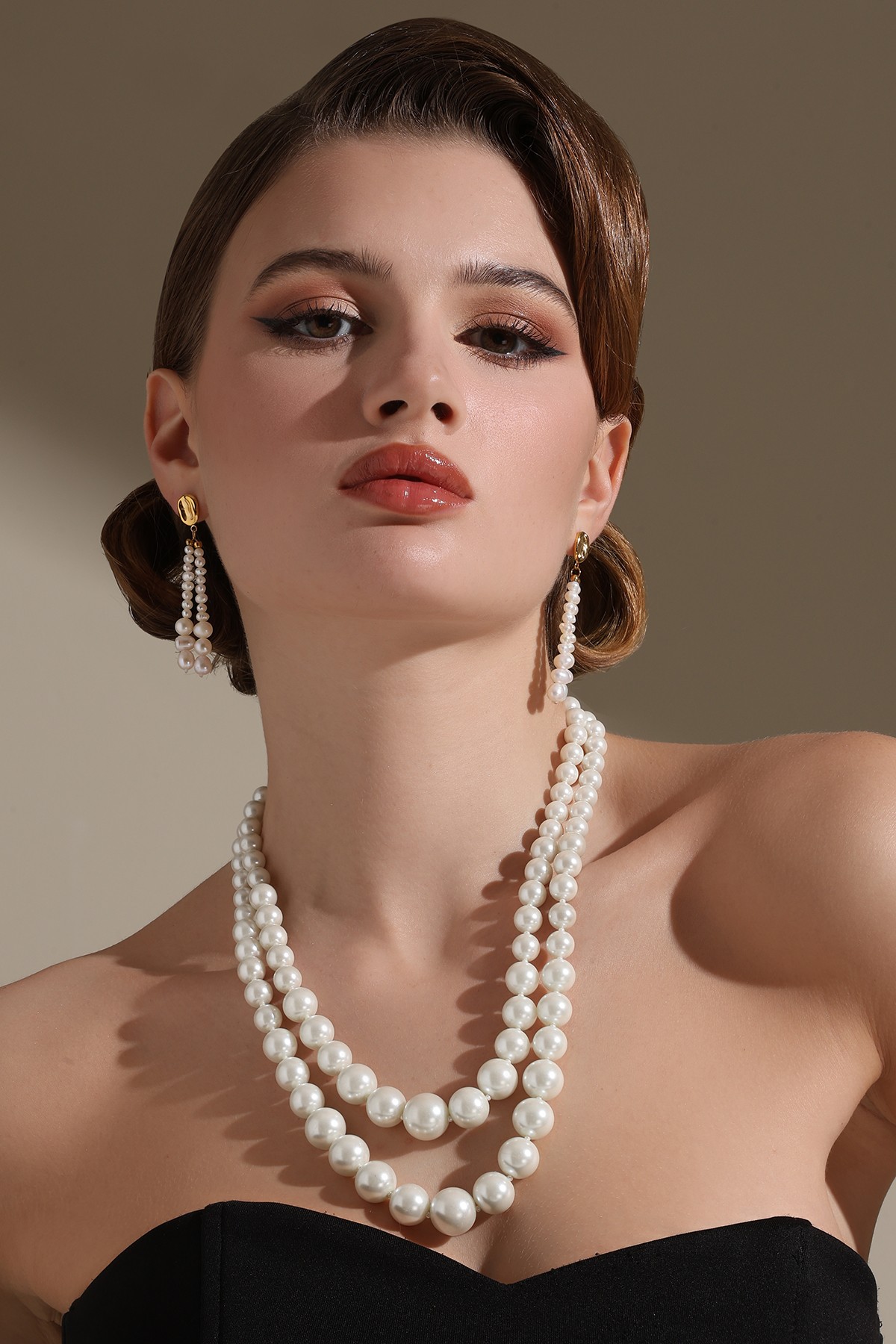 A model showcasing Double Trouble Necklace by Dusala from Dusala's collection A model showcasing Double Trouble Necklace by Dusala from Dusala's collection