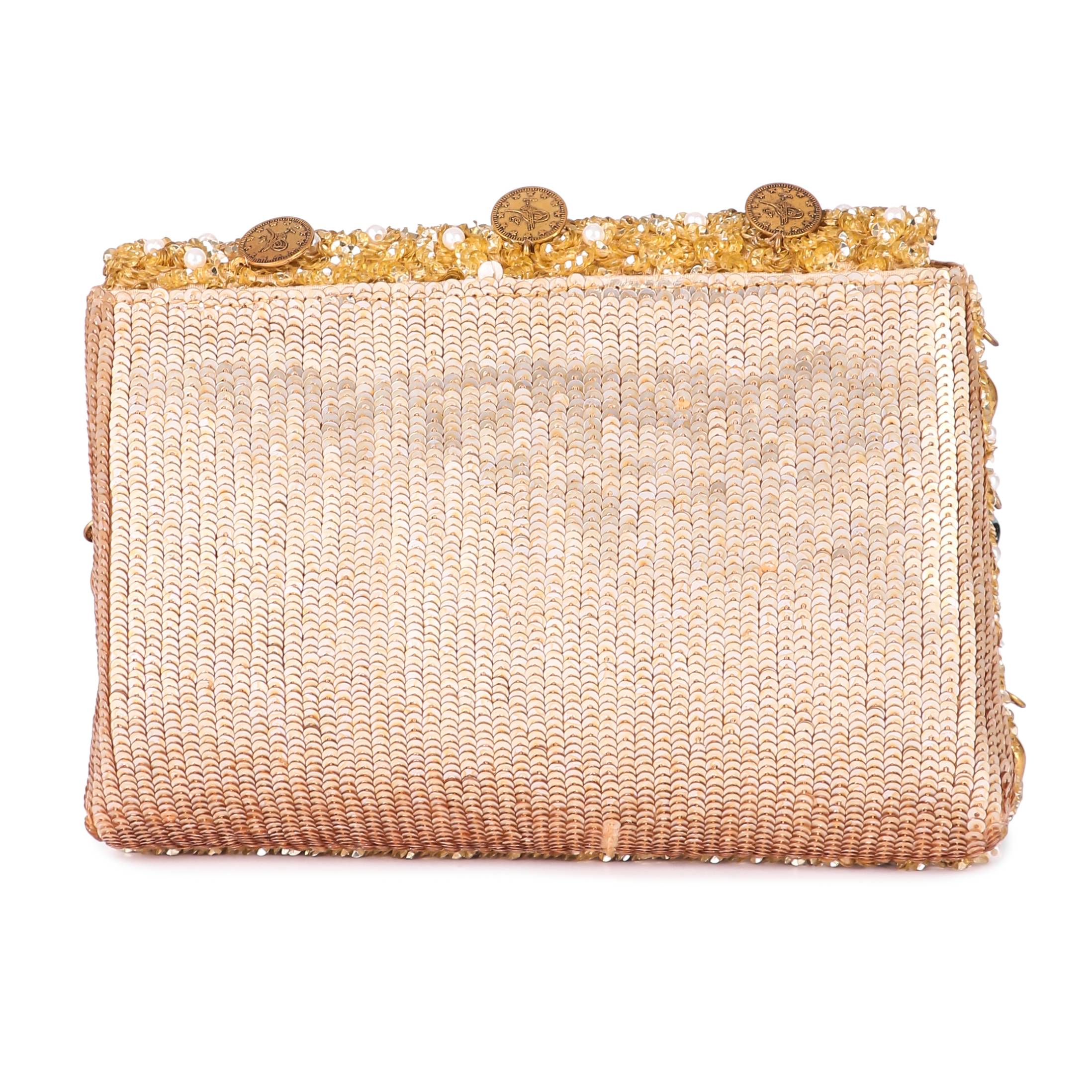 A model showcasing Evil Eye Gold Clutch by The Purple Sack from The Purple Sack's collection A model showcasing Evil Eye Gold Clutch by The Purple Sack from The Purple Sack's collection