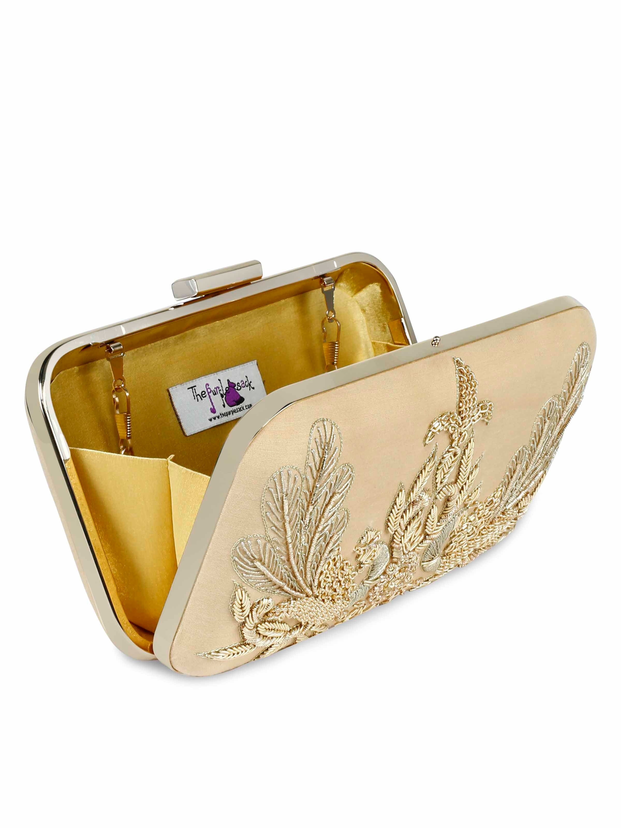 A model showcasing Golden Peacock Clutch by The Purple Sack from The Purple Sack's collection A model showcasing Golden Peacock Clutch by The Purple Sack from The Purple Sack's collection