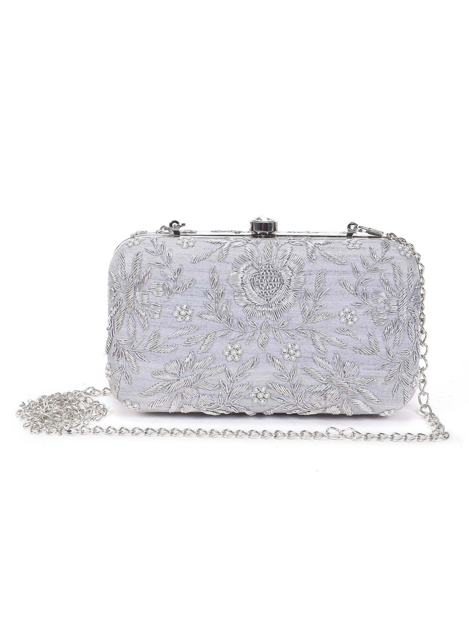 A model showcasing Pleasing Silver Clutch by The Purple Sack from The Purple Sack's collection A model showcasing Pleasing Silver Clutch by The Purple Sack from The Purple Sack's collection