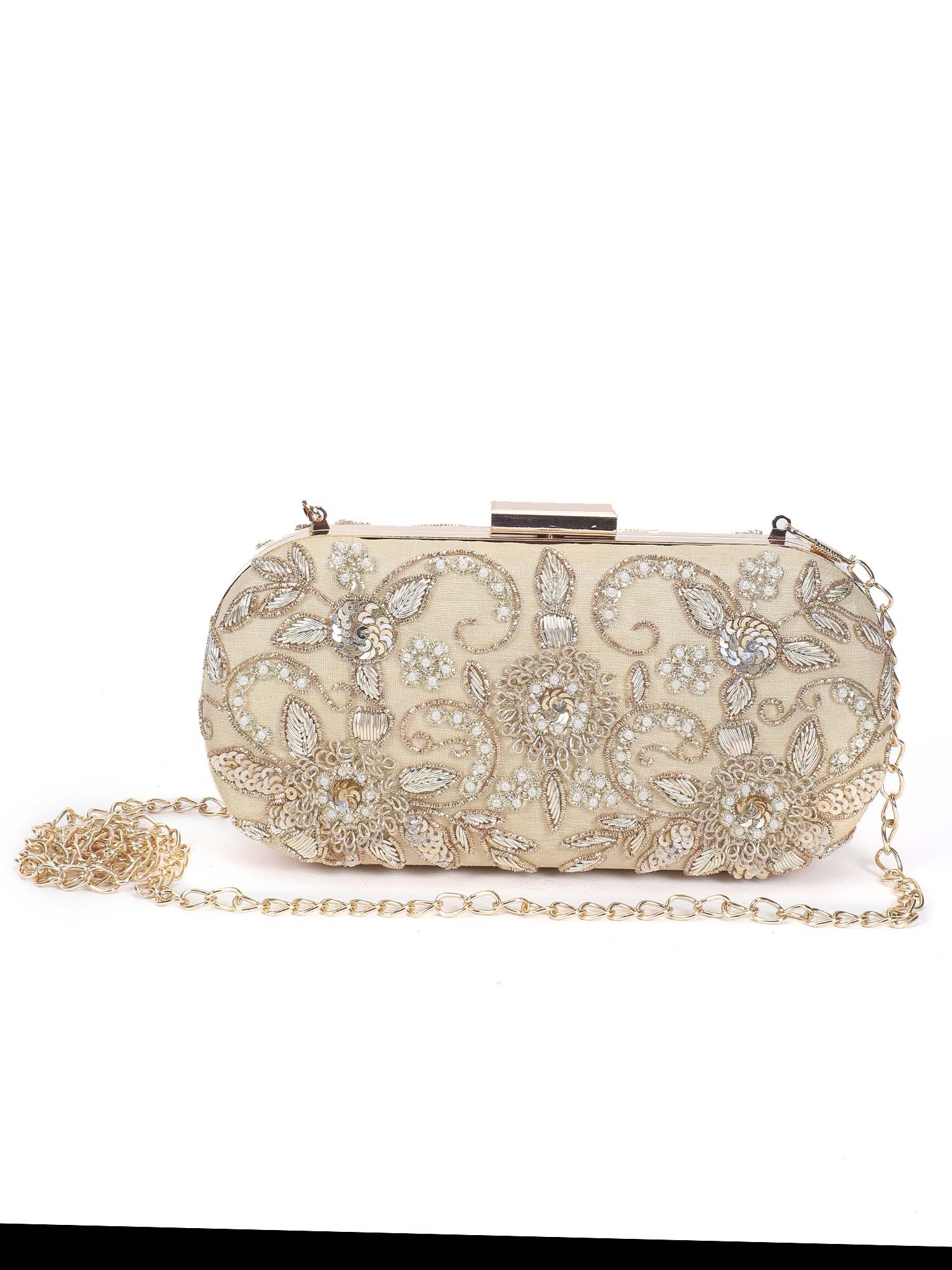 A model showcasing Thandai Gold Clutch by The Purple Sack from The Purple Sack's collection