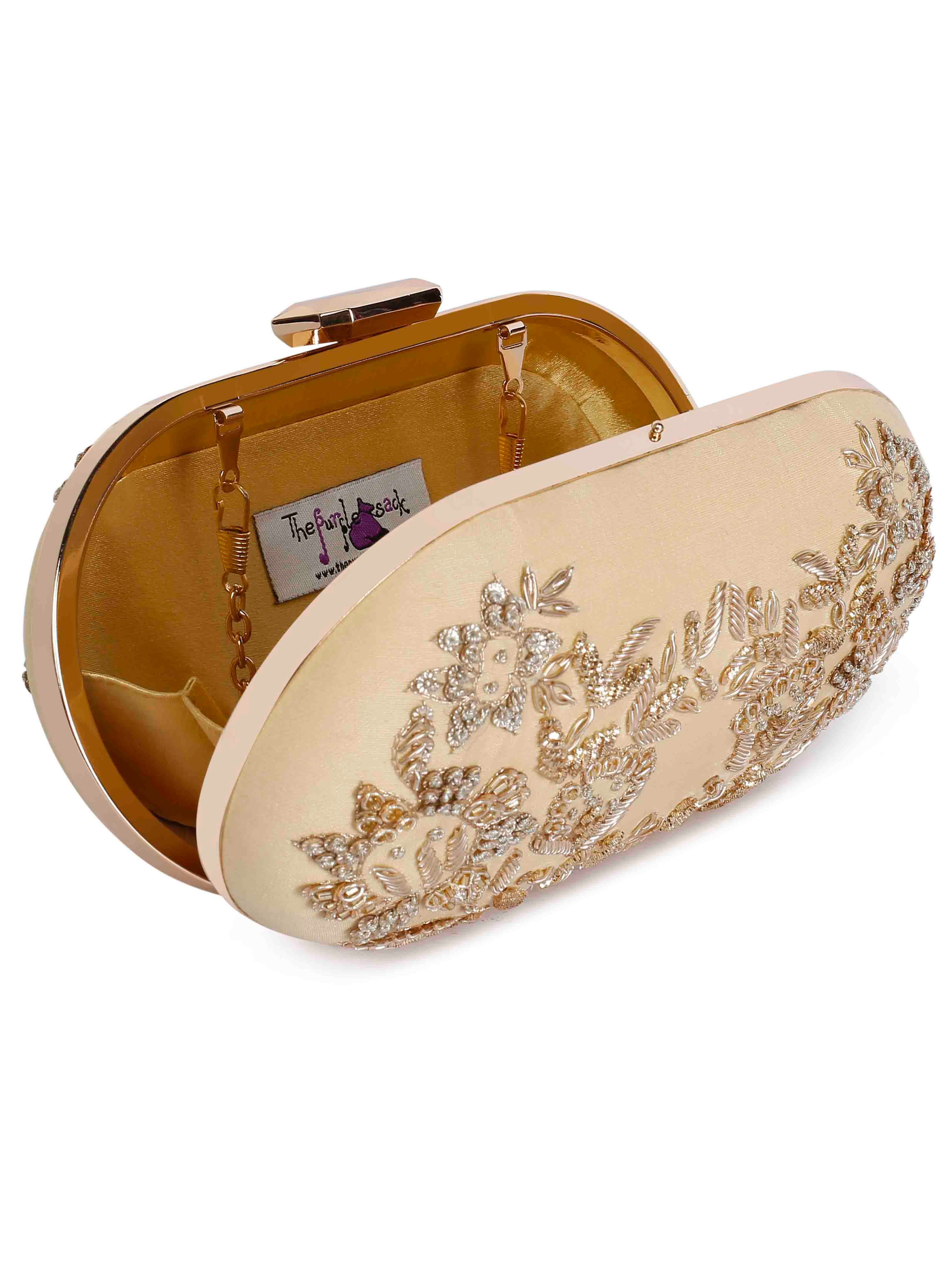 A model showcasing Zardosi Golden Oblong Clutch by The Purple Sack from The Purple Sack's collection