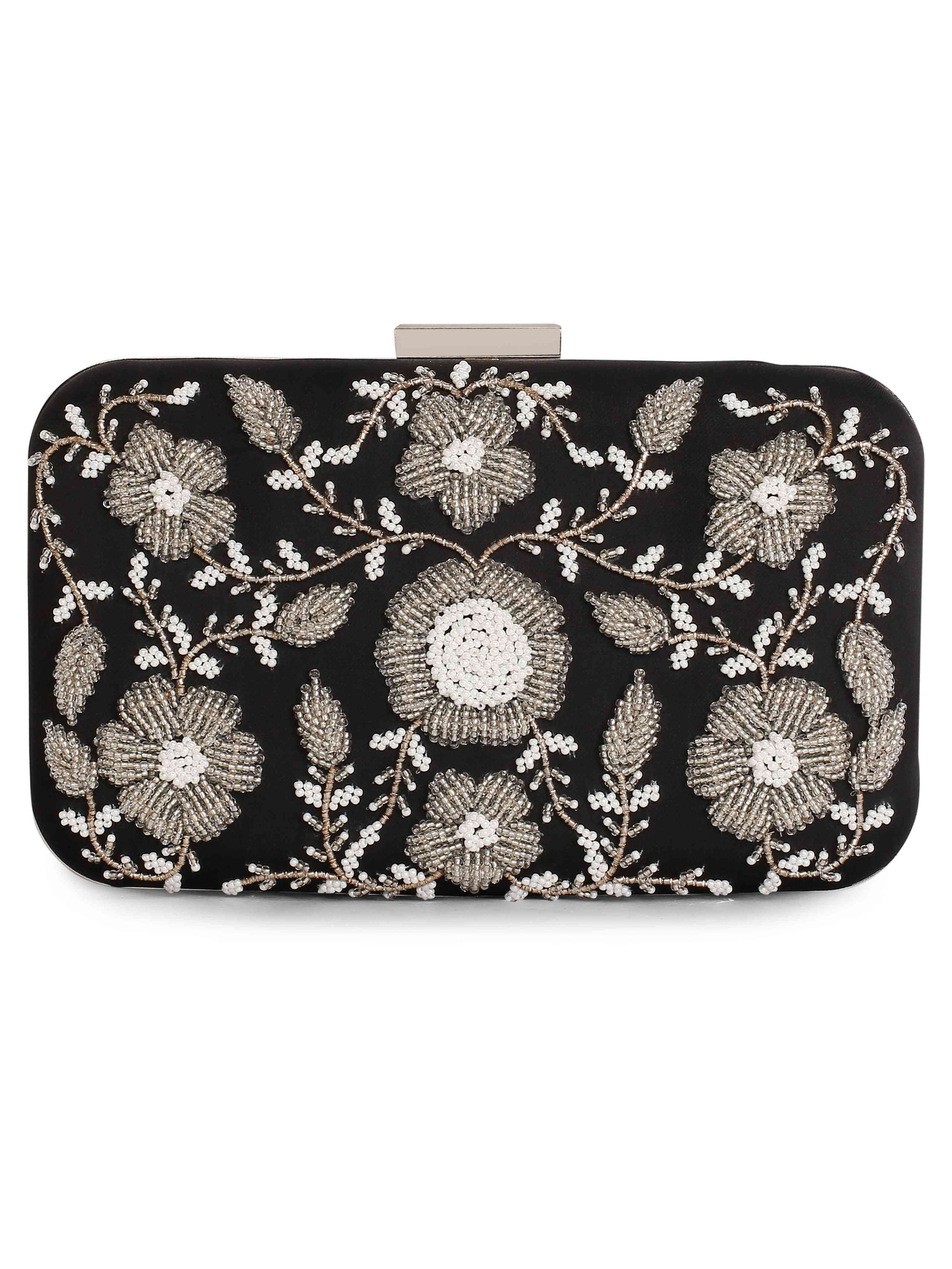 A model showcasing Black Ornate Clutch by The Purple Sack from The Purple Sack's collection