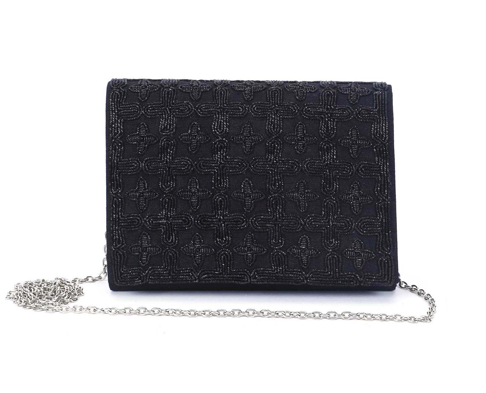 A model showcasing Black Jaal Clutch by The Purple Sack from The Purple Sack's collection