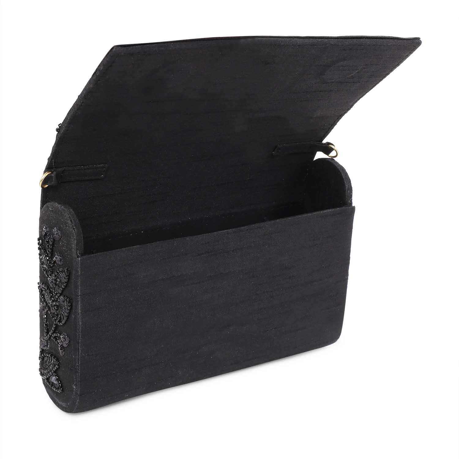 A model showcasing Black On Black Clutch by The Purple Sack from The Purple Sack's collection A model showcasing Black On Black Clutch by The Purple Sack from The Purple Sack's collection