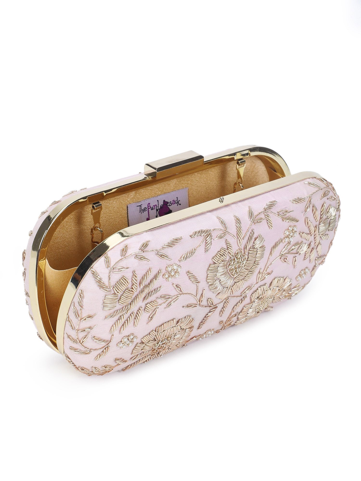 A model showcasing Pretty Pink Floral Clutch by The Purple Sack from The Purple Sack's collection A model showcasing Pretty Pink Floral Clutch by The Purple Sack from The Purple Sack's collection