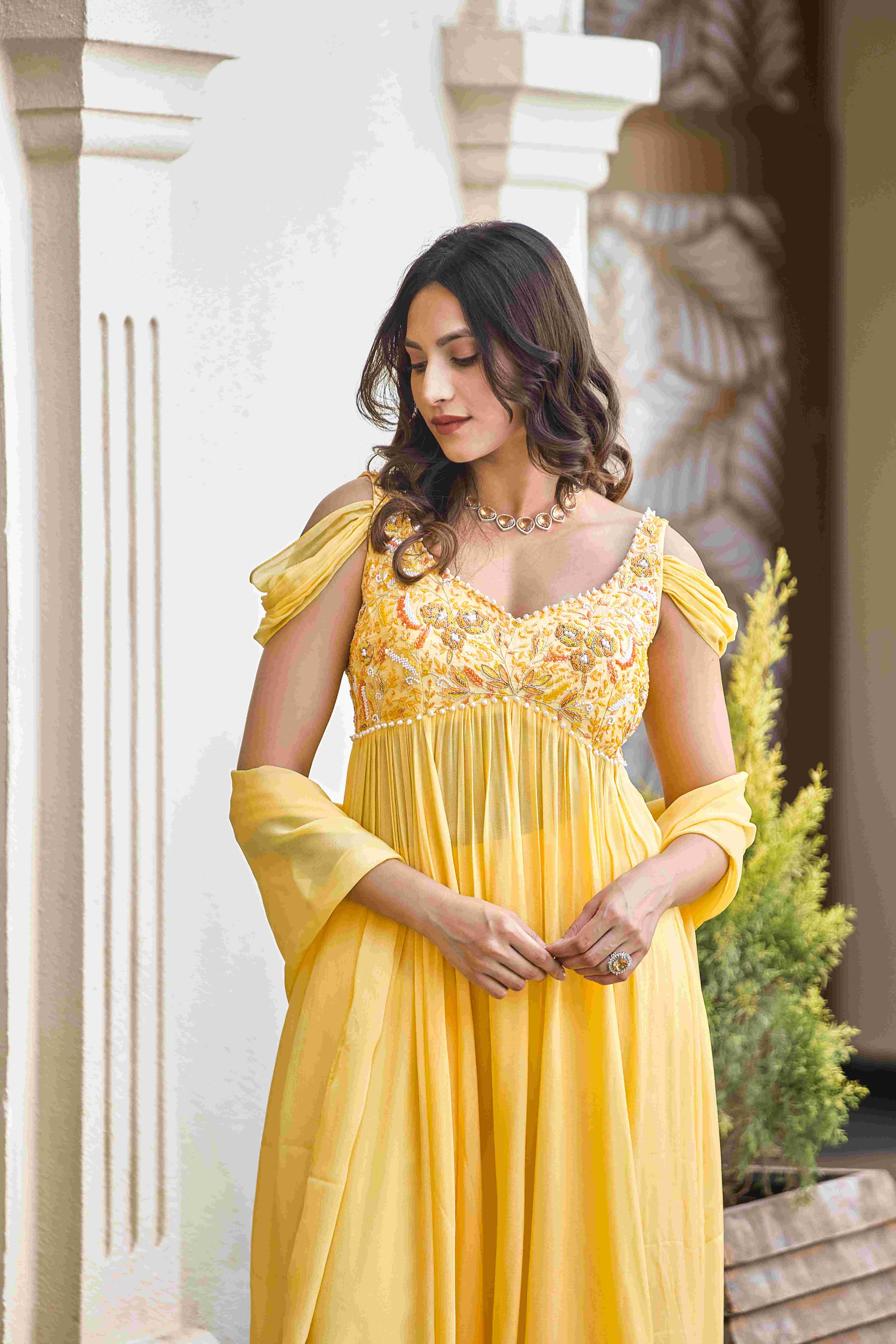 A model showcasing Golden Whispers Sharara Suit by D And V from D And V's collection