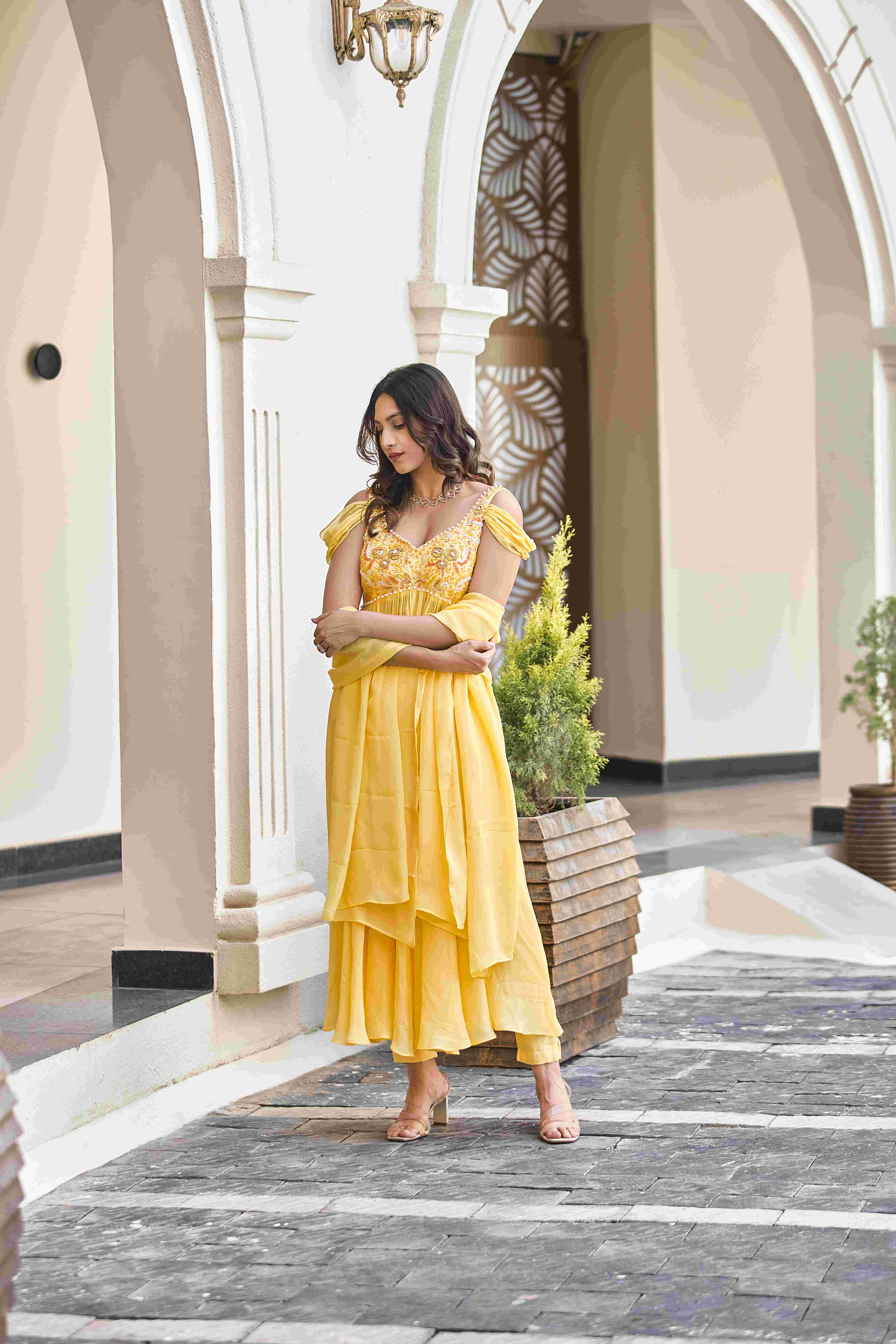 A model showcasing Golden Whispers Sharara Suit by D And V from D And V's collection