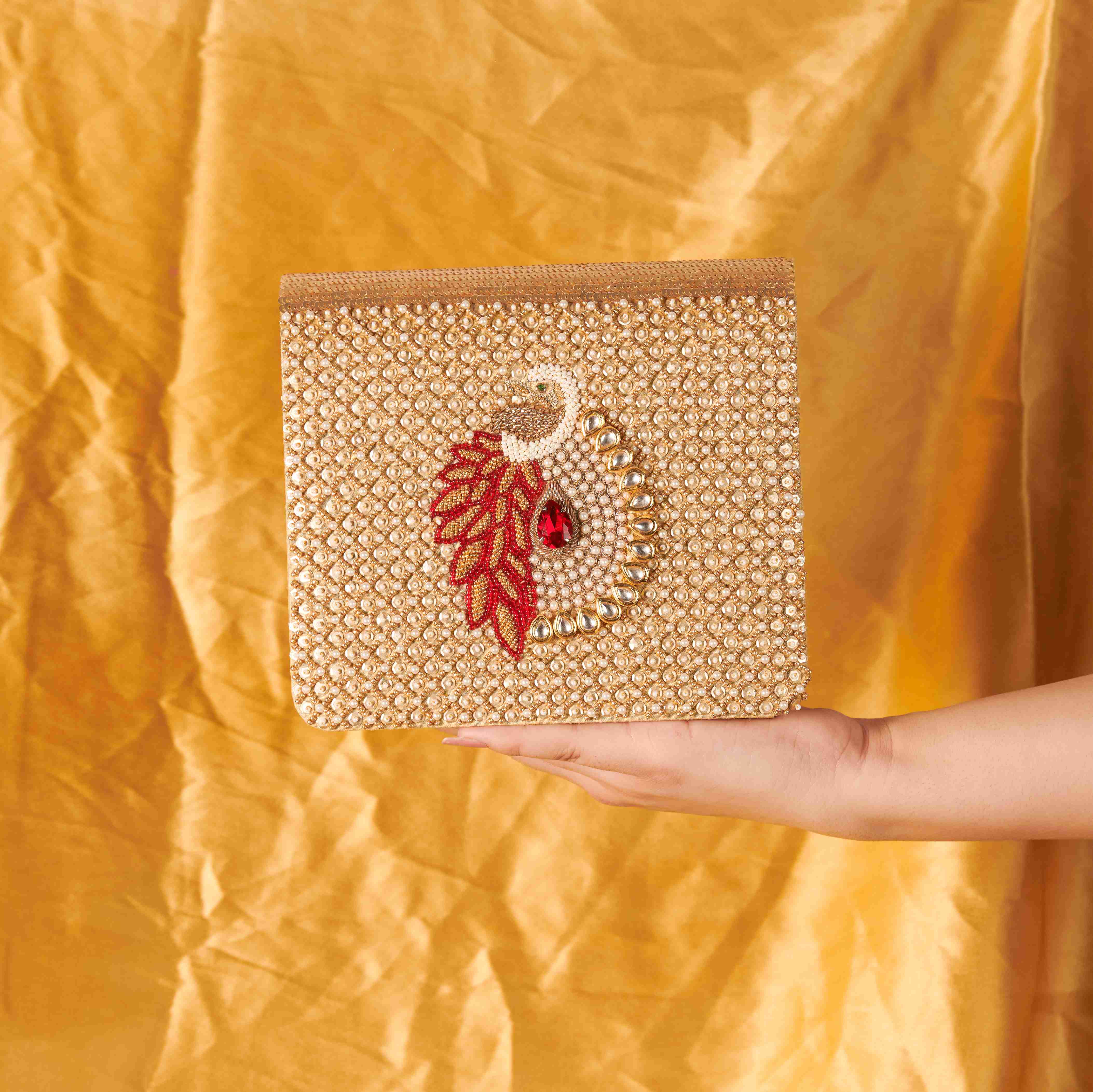 A model showcasing Mayuraa Clutch by The Purple Sack from The Purple Sack's collection A model showcasing Mayuraa Clutch by The Purple Sack from The Purple Sack's collection