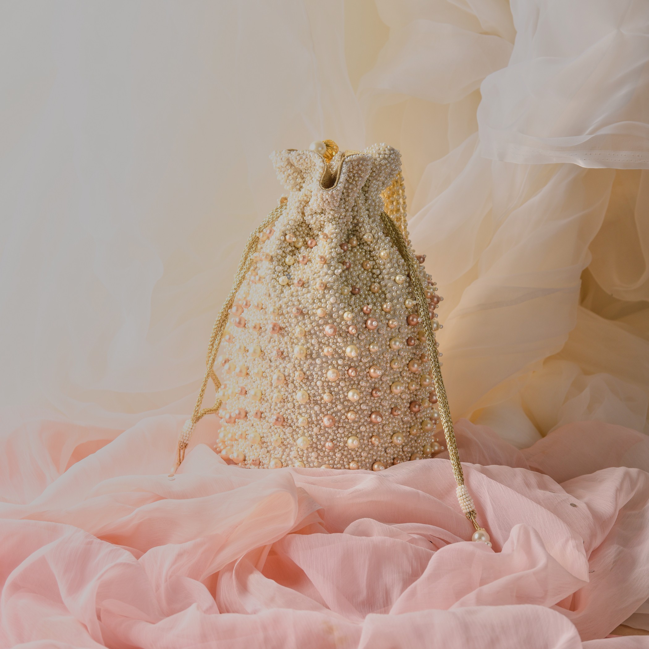 A model showcasing Sweet Pearls Potli by The Purple Sack from The Purple Sack's collection