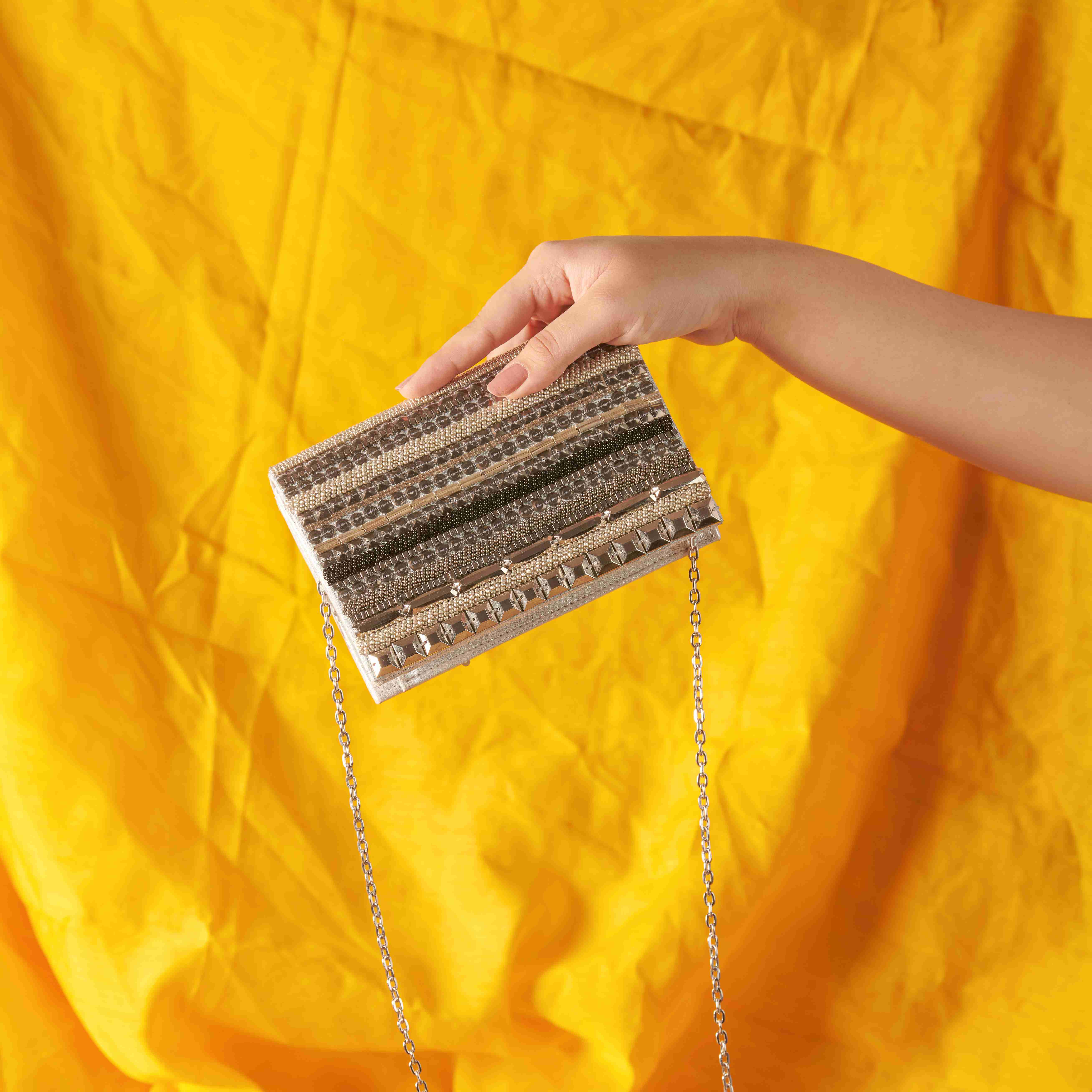 A model showcasing Sequcee Clutch by The Purple Sack from The Purple Sack's collection