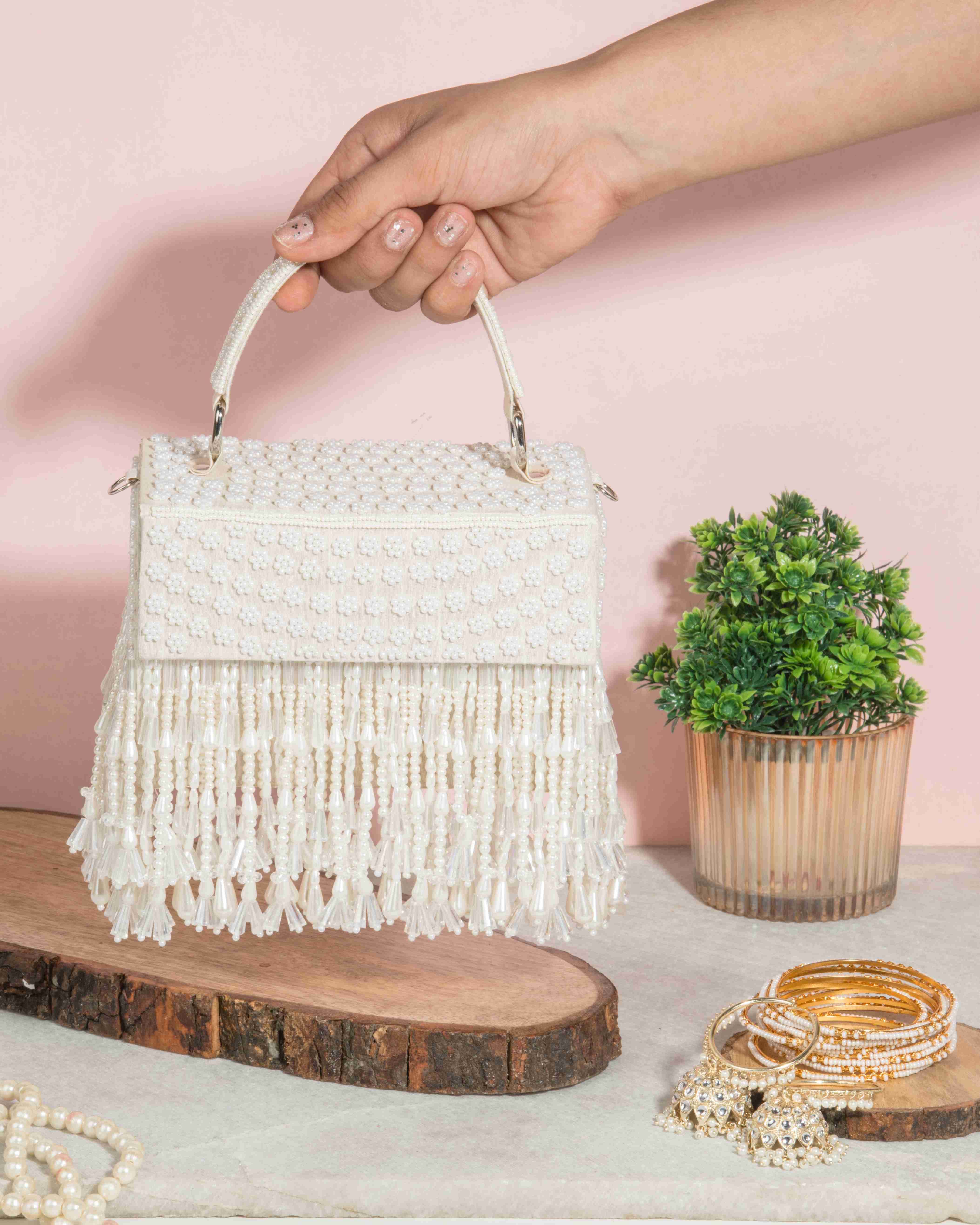 A model showcasing The Apsara Clutch by The Purple Sack from The Purple Sack's collection